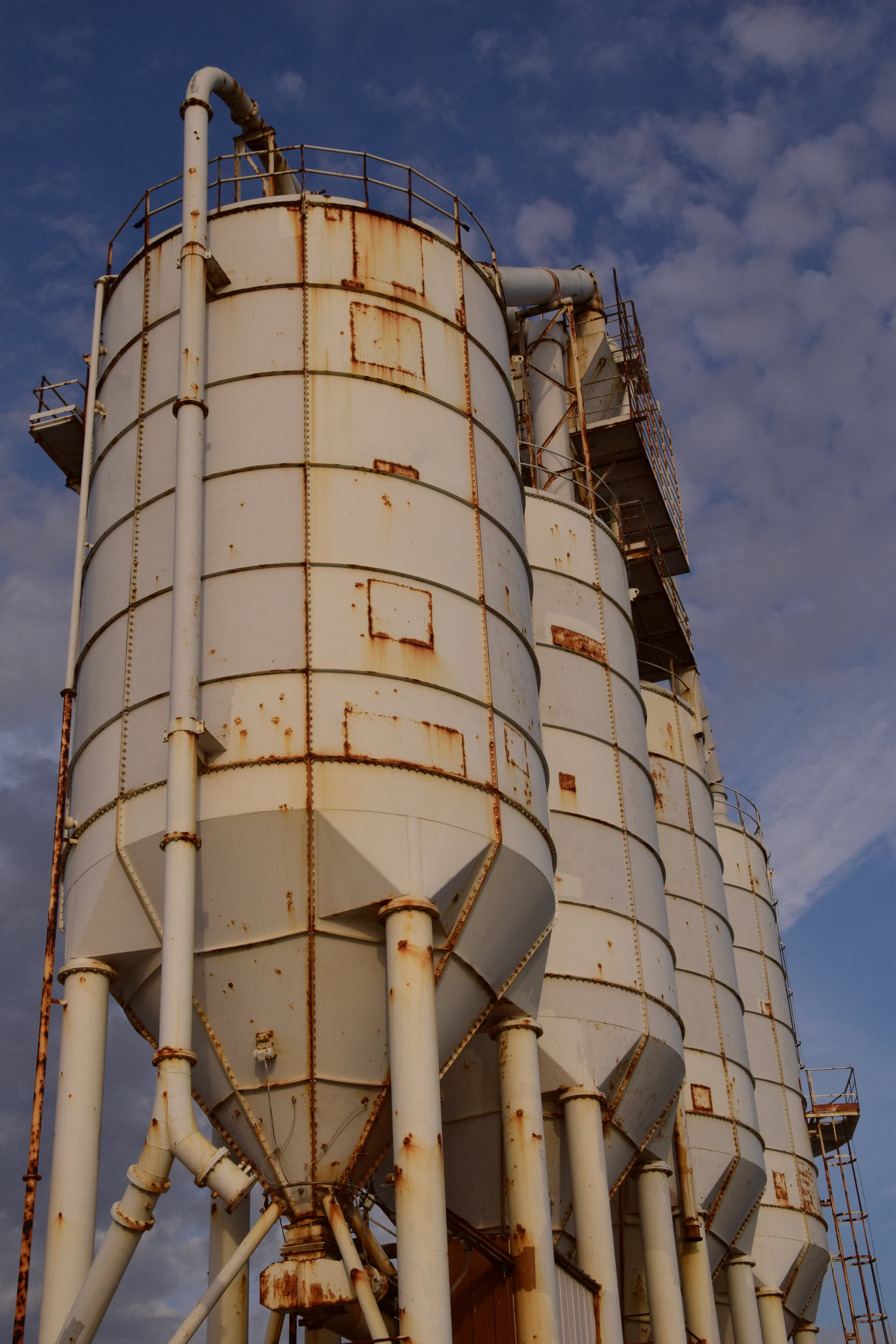 old silo, cloud - sky, cylinder, day, factory, industry, outdoors, 5K, low angle view, nature, architecture, cement silo, metal, stock, storage tank, built structure, Phone HD Wallpaper
