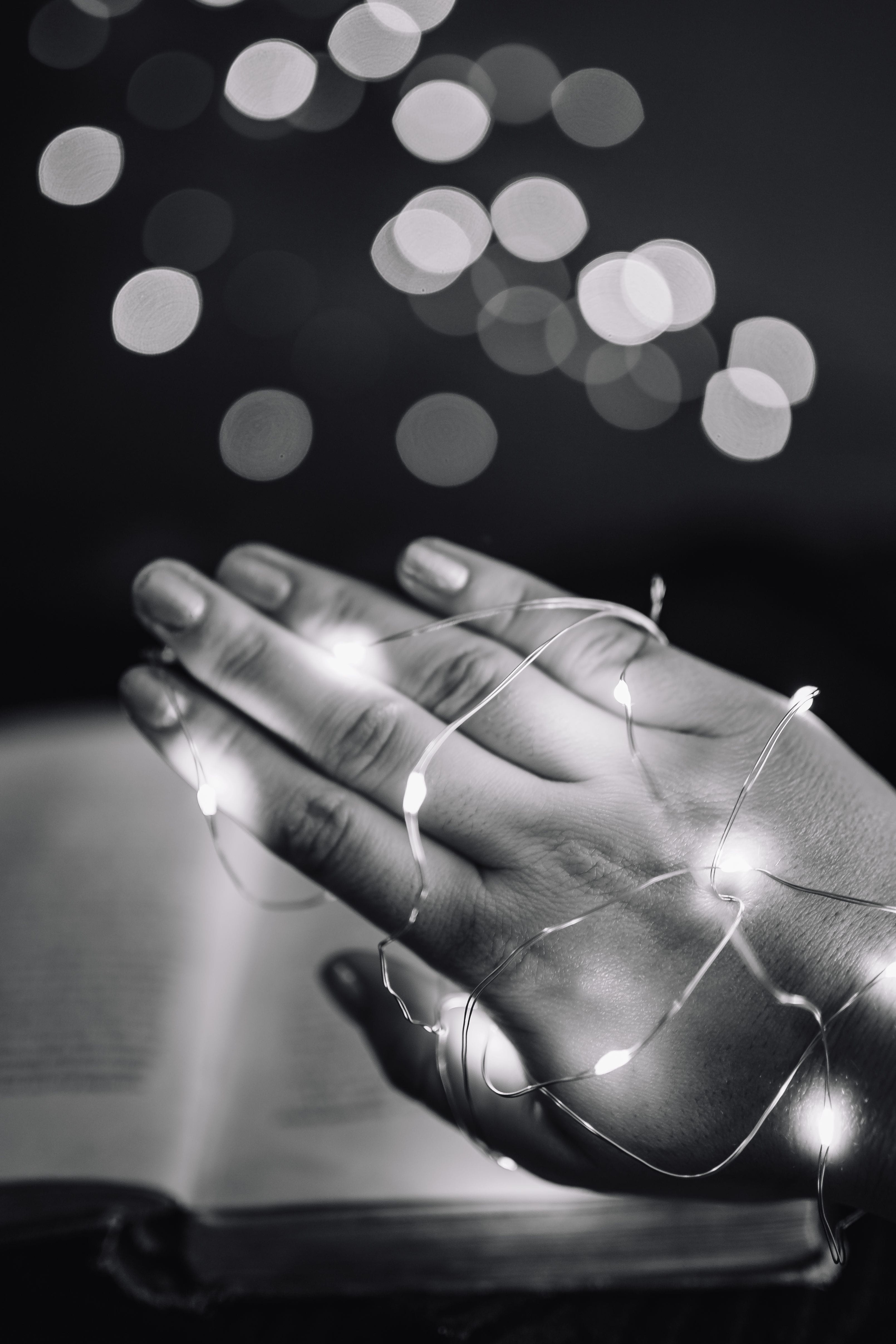 one Person, holding, night, making, 4K, time, human body part, black And White, human Hand, body part, Fairy Lights, illuminated, focus on foreground, Phone HD Wallpaper