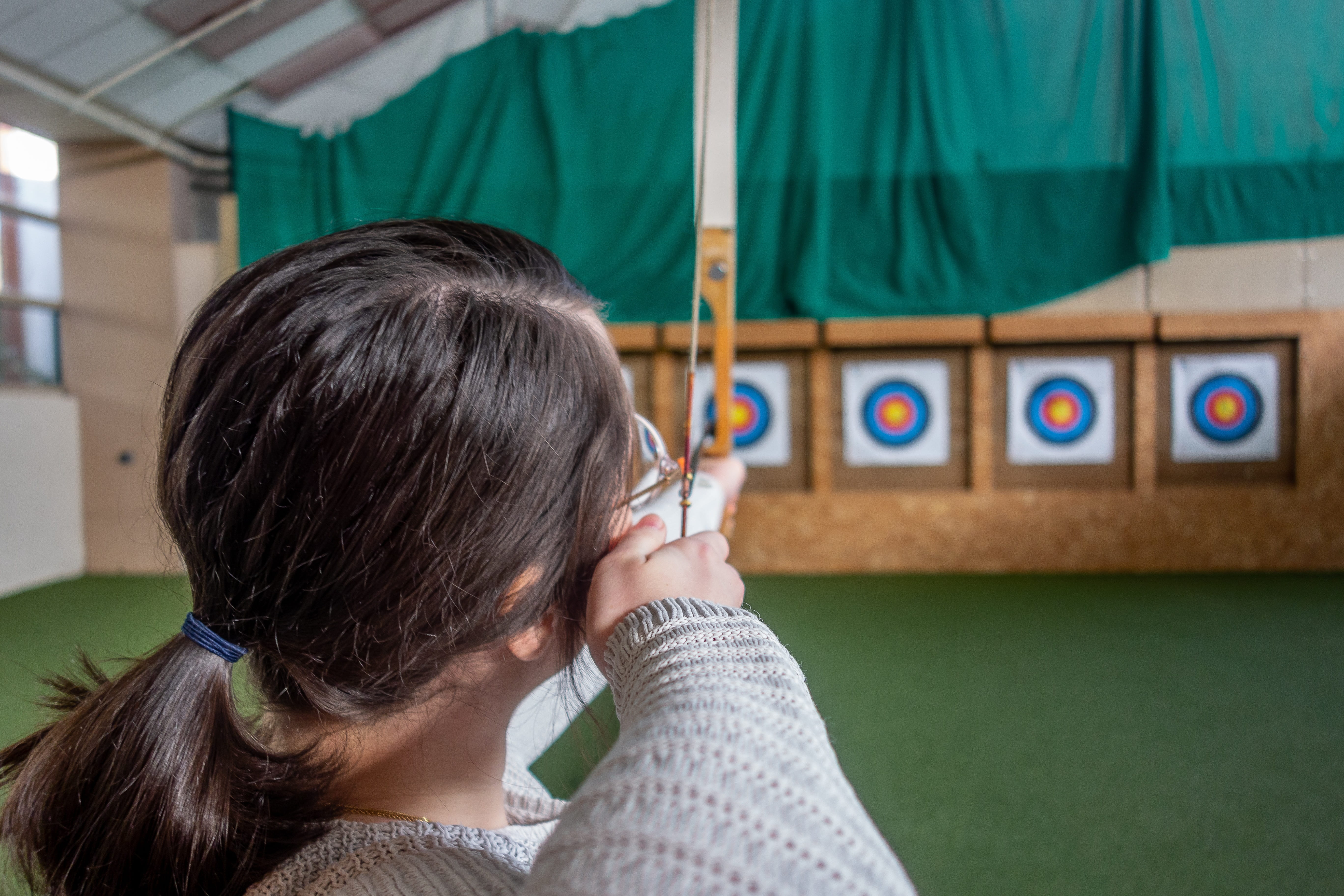 focus on foreground, black hair, person, target, archer, indoors, headshot, architecture, portrait, objective, leisure activity, adult, sport, 5K, child, HD Wallpaper