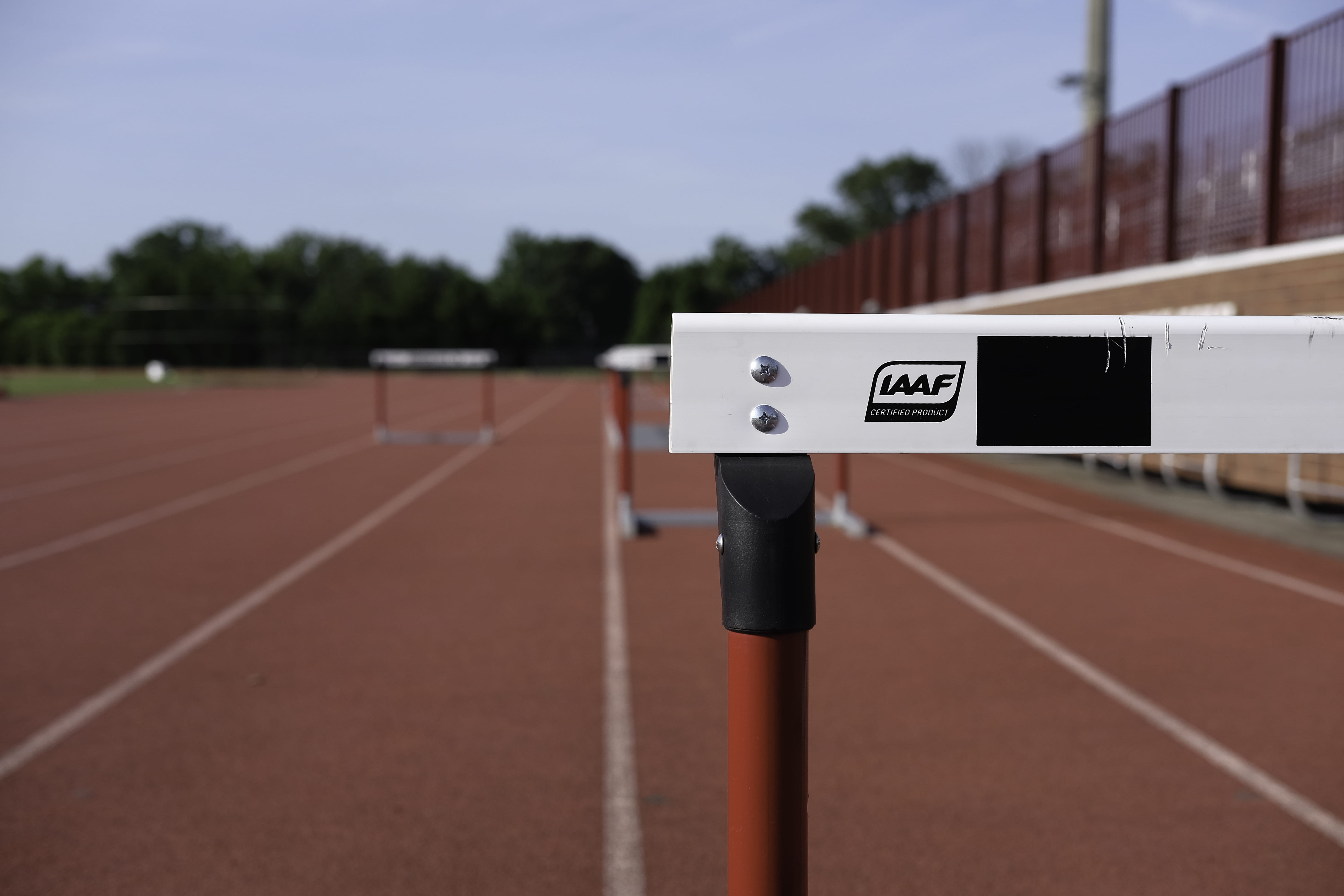 day, text, field, outdoors, sport, red, sawhorse, green, no people, nature, competition, bokeh, wall, selective focus, sky, line, hurdle, sunny, sports track, HD Wallpaper
