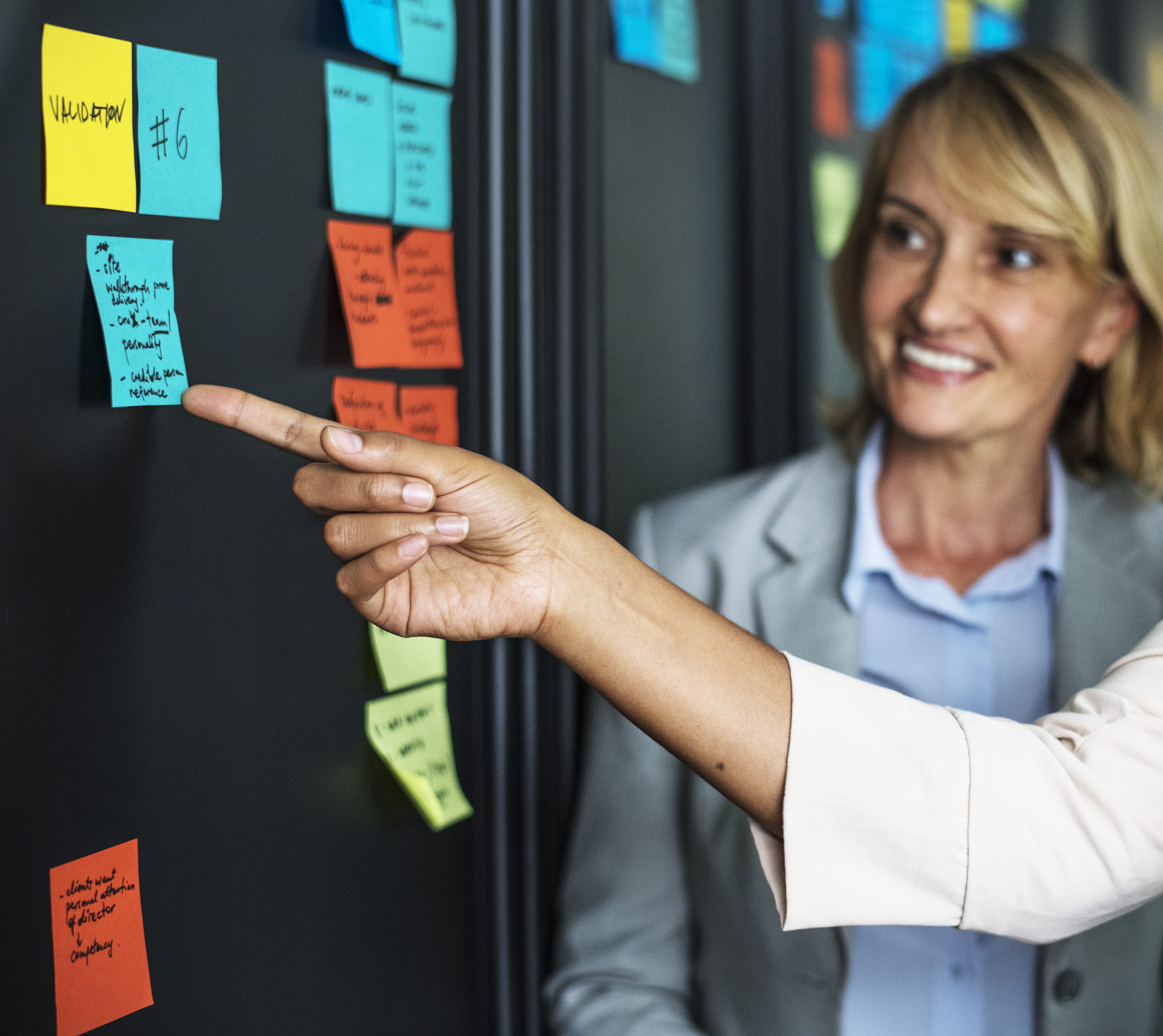 togetherness, working, mature adult, pointing, notes, wall, teamwork, businesswomen, one person, people, meeting room, coworkers, planning, sticky notes, HD Wallpaper