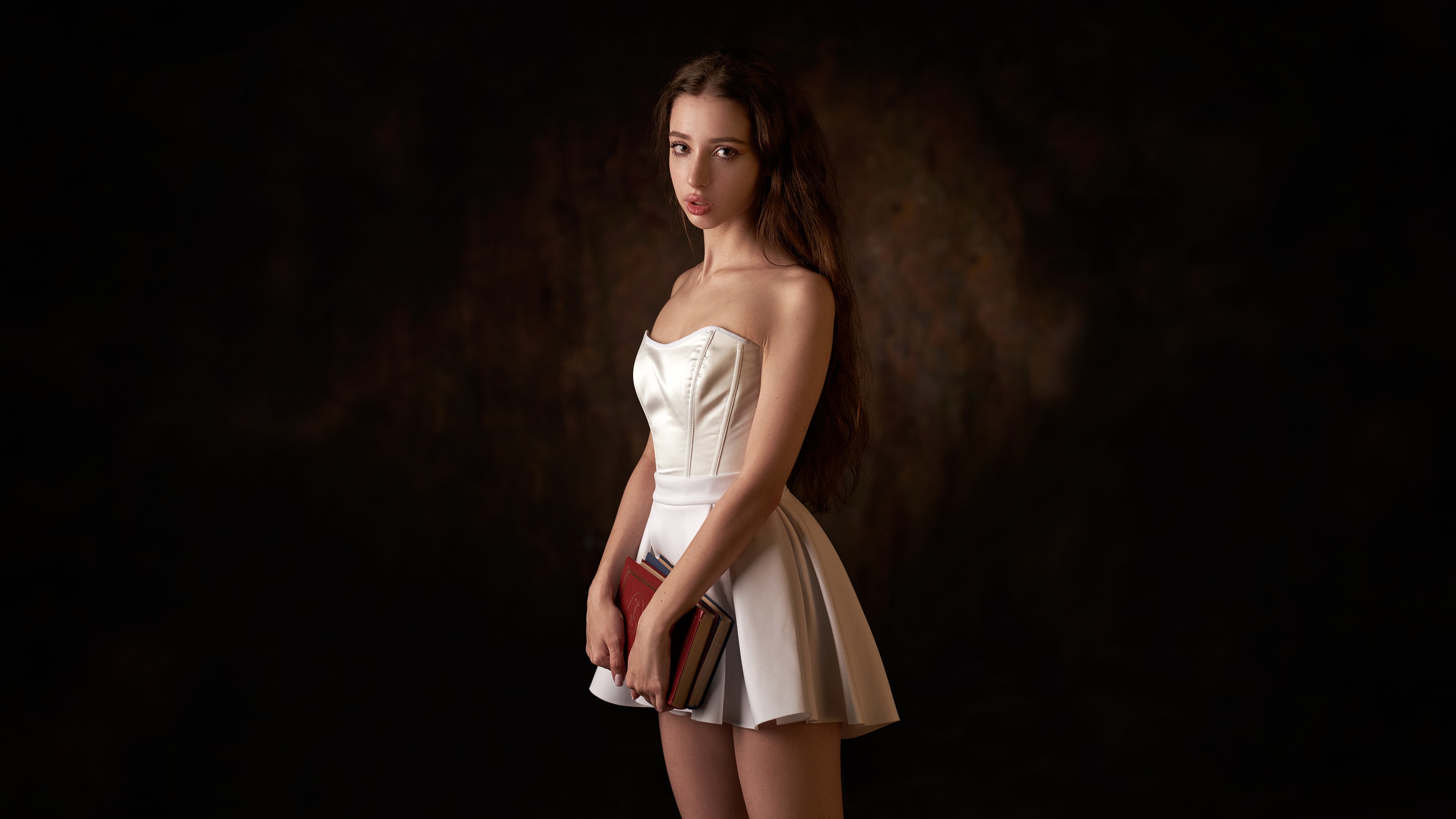 portrait, 4K, parted lips, vignette, brown eyes, women, dress, bare shoulders, books, black, long hair, Max Pyzhik, model, cleavage, white dress, dark background, HD Wallpaper