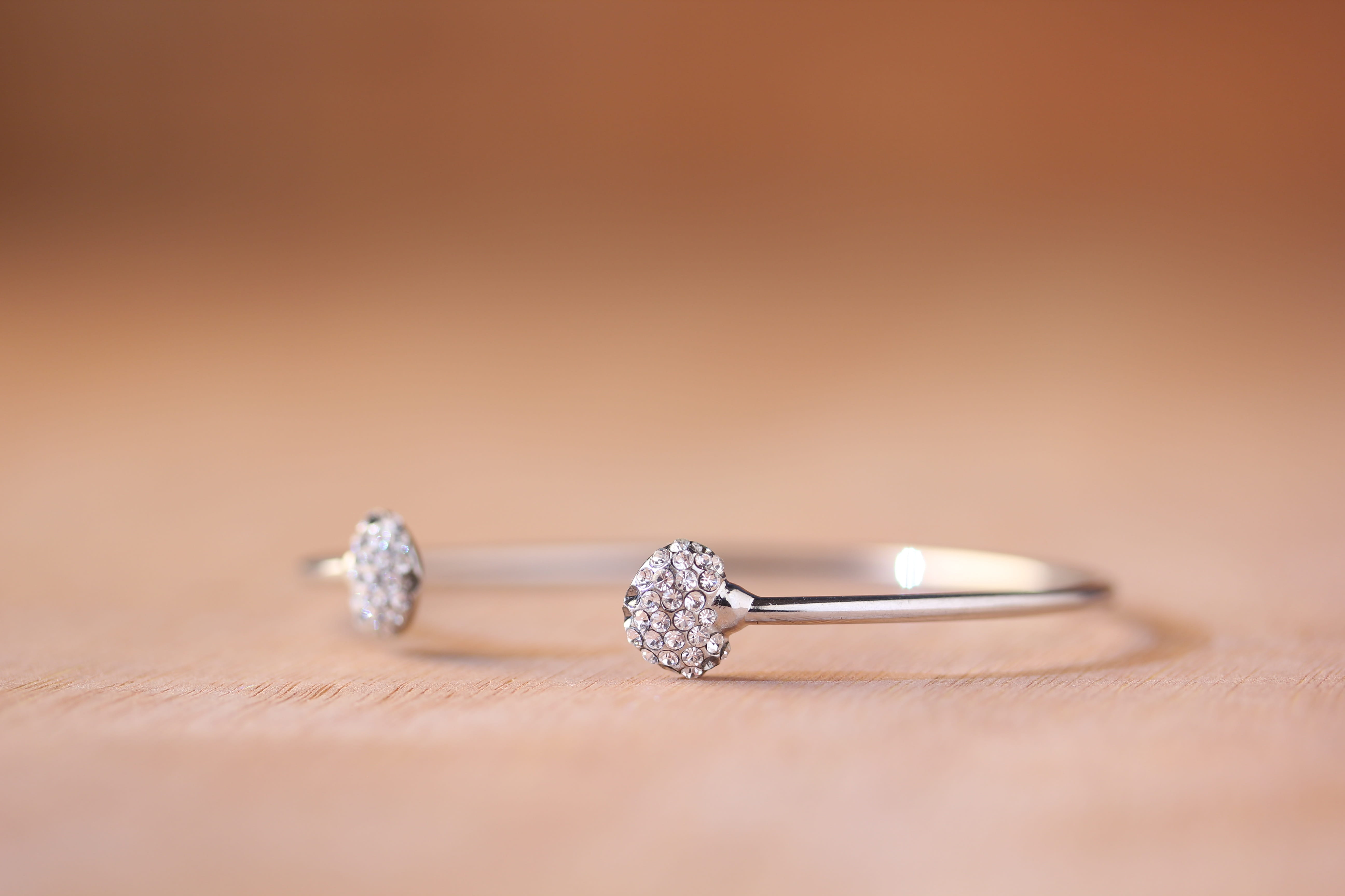 copy space, silver colored, ring, expense, blur, studio shot, engagement ring, celebration, wealth, shiny, luxury, selective focus, jewelry, table, wood - material, HD Wallpaper
