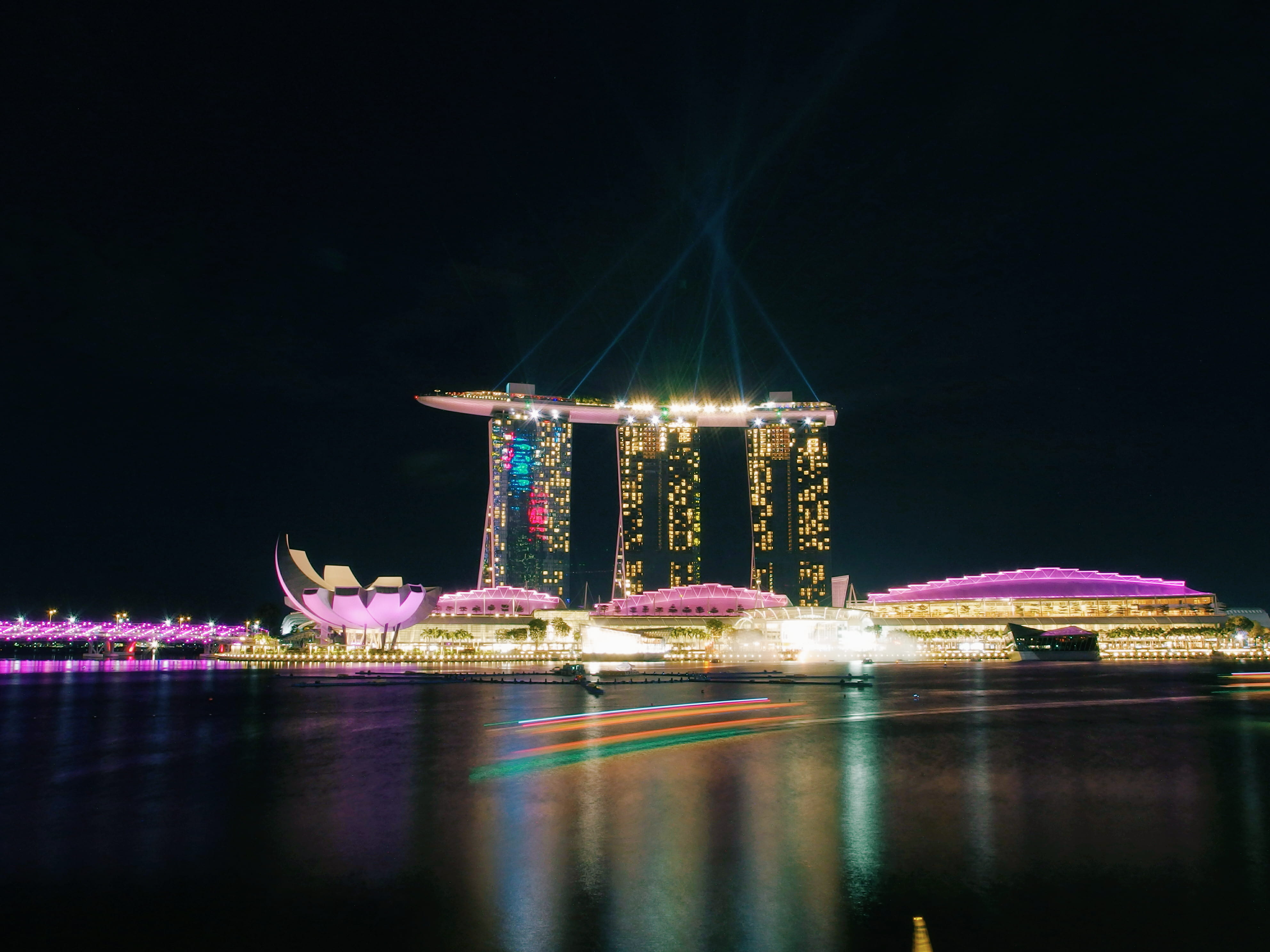 sea, built structure, neon lights, lighttrail, night, amusement park, high, nightlife, luxury, outdoors, amusement park ride, nature, skyscraper, marinabaysand, HD Wallpaper
