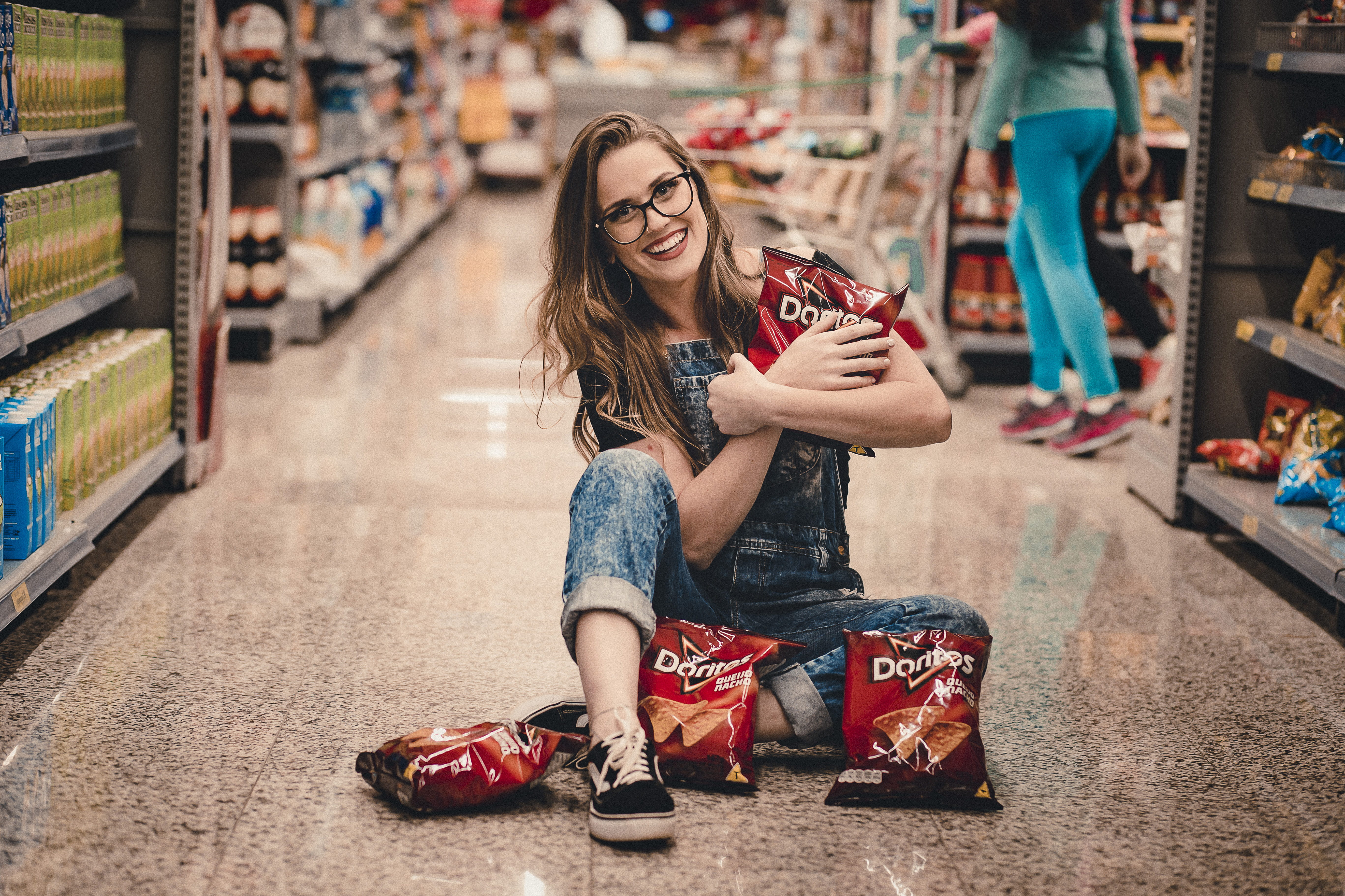 women, floor, posing, adult, chips, beauty, casual clothing, doritos, smiling, woman, aisle, glasses, happy, sitting, females, shoe, casual wear, middle, HD Wallpaper