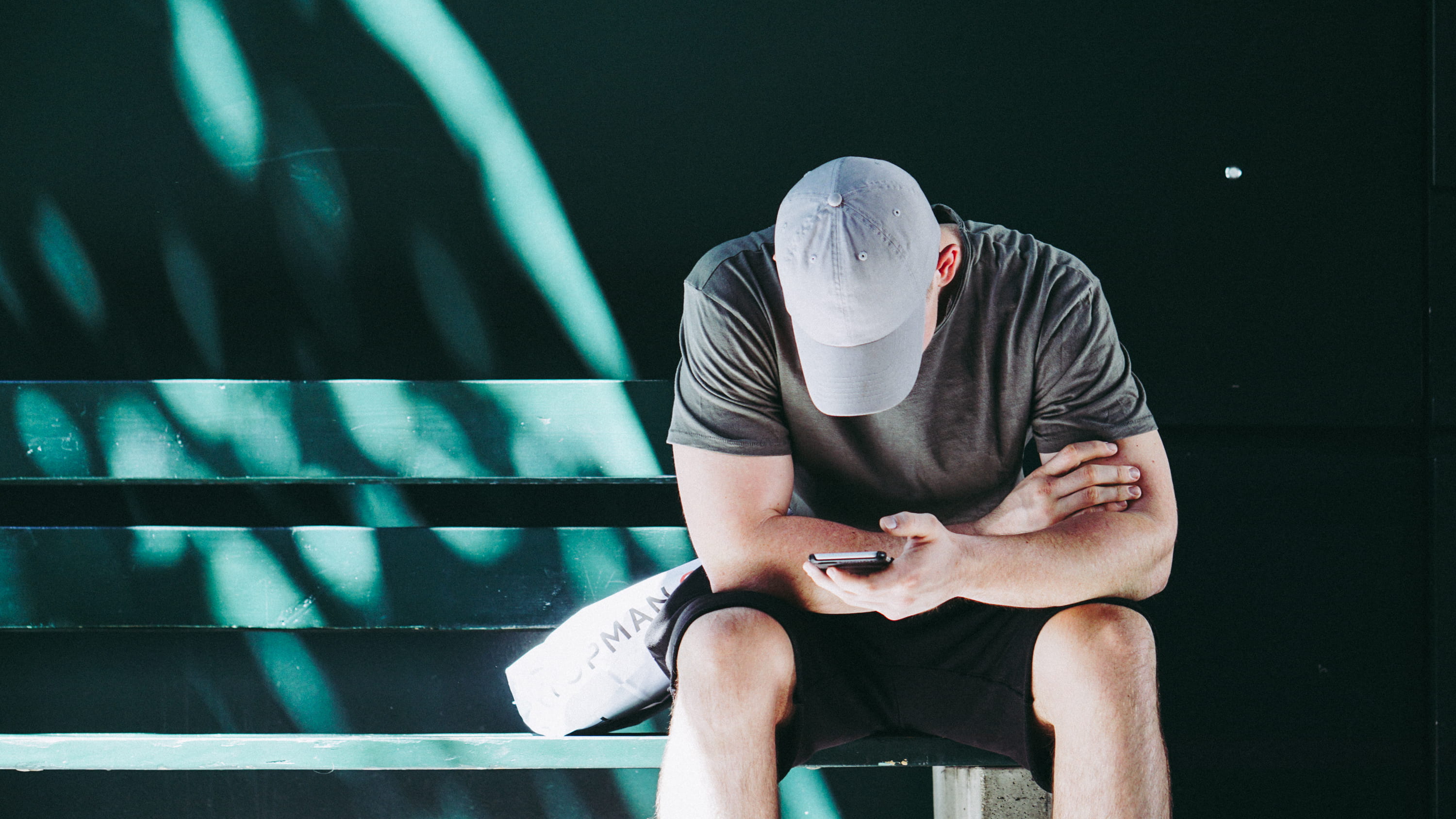 sunlight, looking, phone, men, smartphone, man, shadow, seat, sitting, exercising, hat, adult, leisure activity, males, bench, person, front view, sportsman, HD Wallpaper