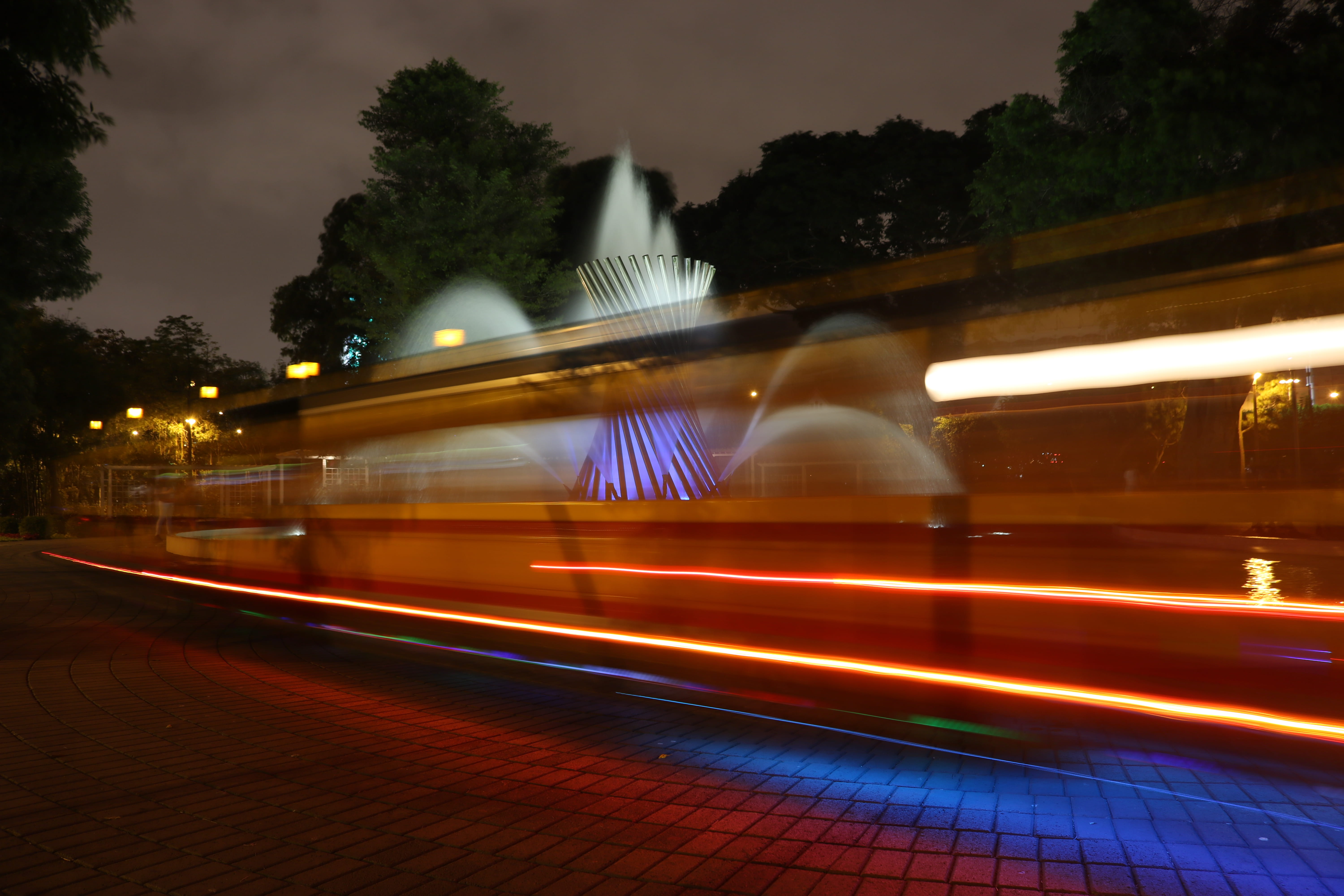 fountain, night, water, plant, asphalt, vehicle, tree, on the move, coat, overcoat, street, motion, city, blurred motion, built structure, tarmac, building exterior, HD Wallpaper