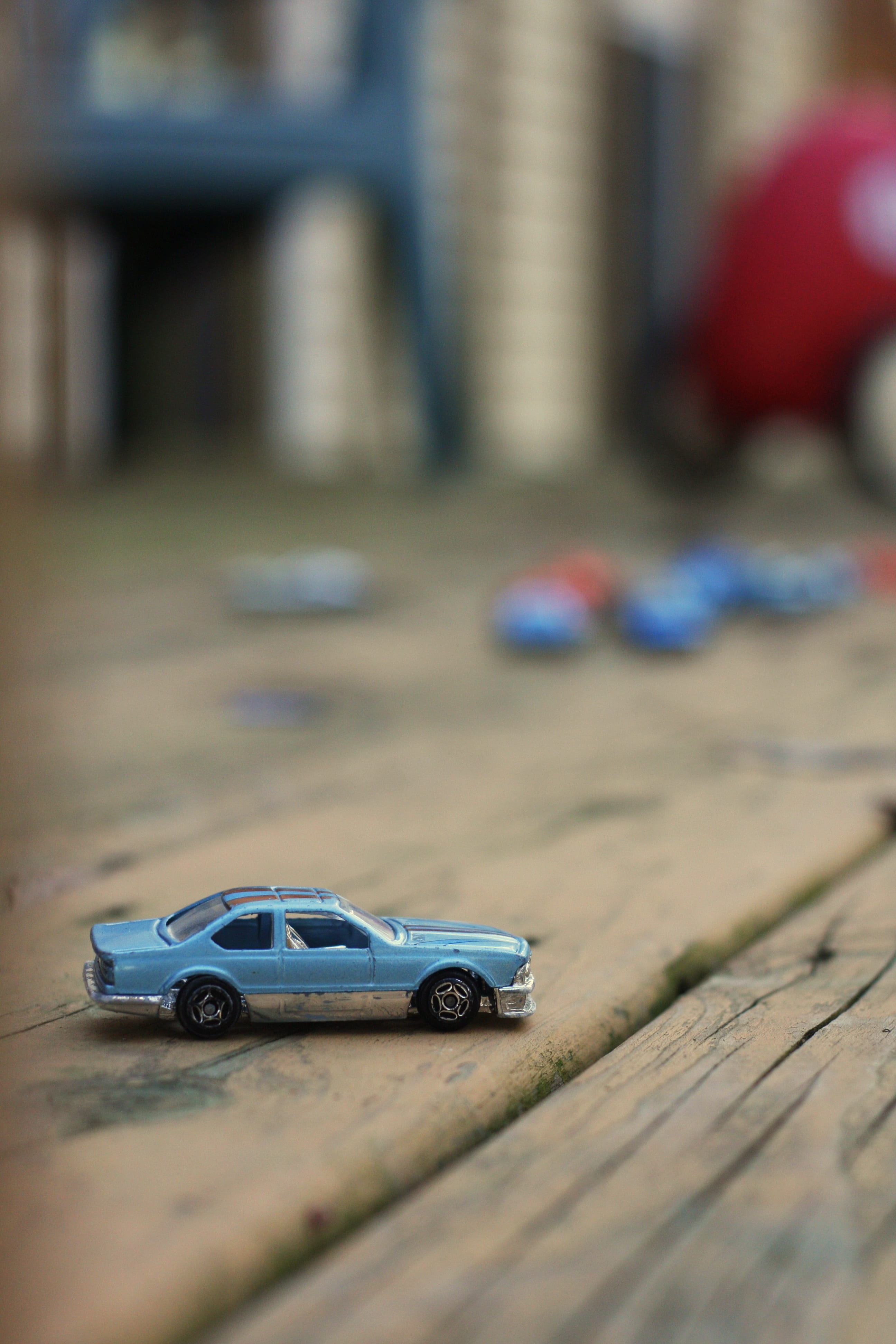 selective focus, close-up, matchbox, no people, city, surface, wood - material, toy car, childhood, transportation, design, built structure, selective, Phone HD Wallpaper