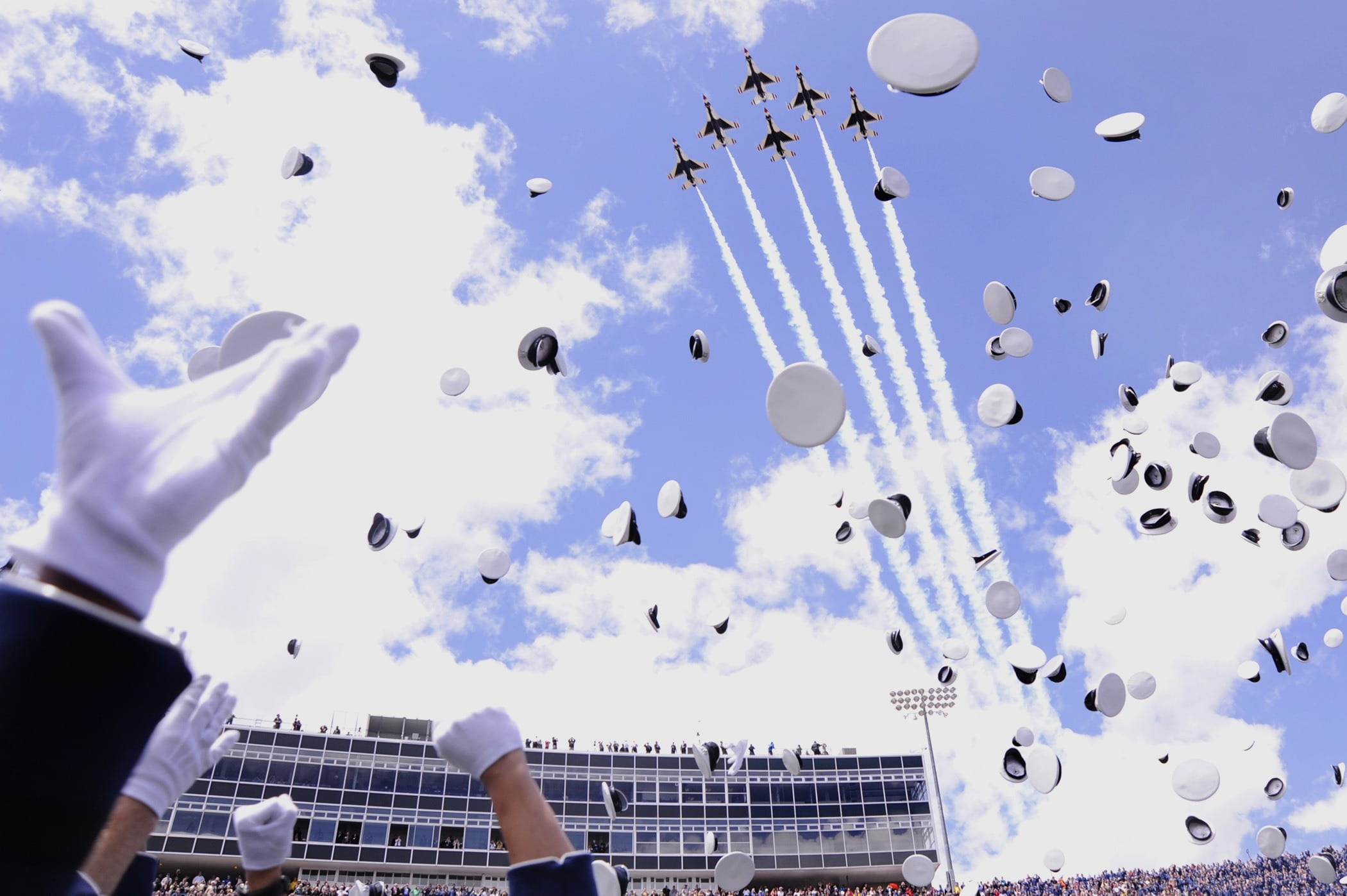 1080P, peakedcaps, human hand, day, accomplishment, cloud - sky, colorado springs, falling, jets, clouds, building exterior, graduation, skyscraper, ceremony, HD Wallpaper