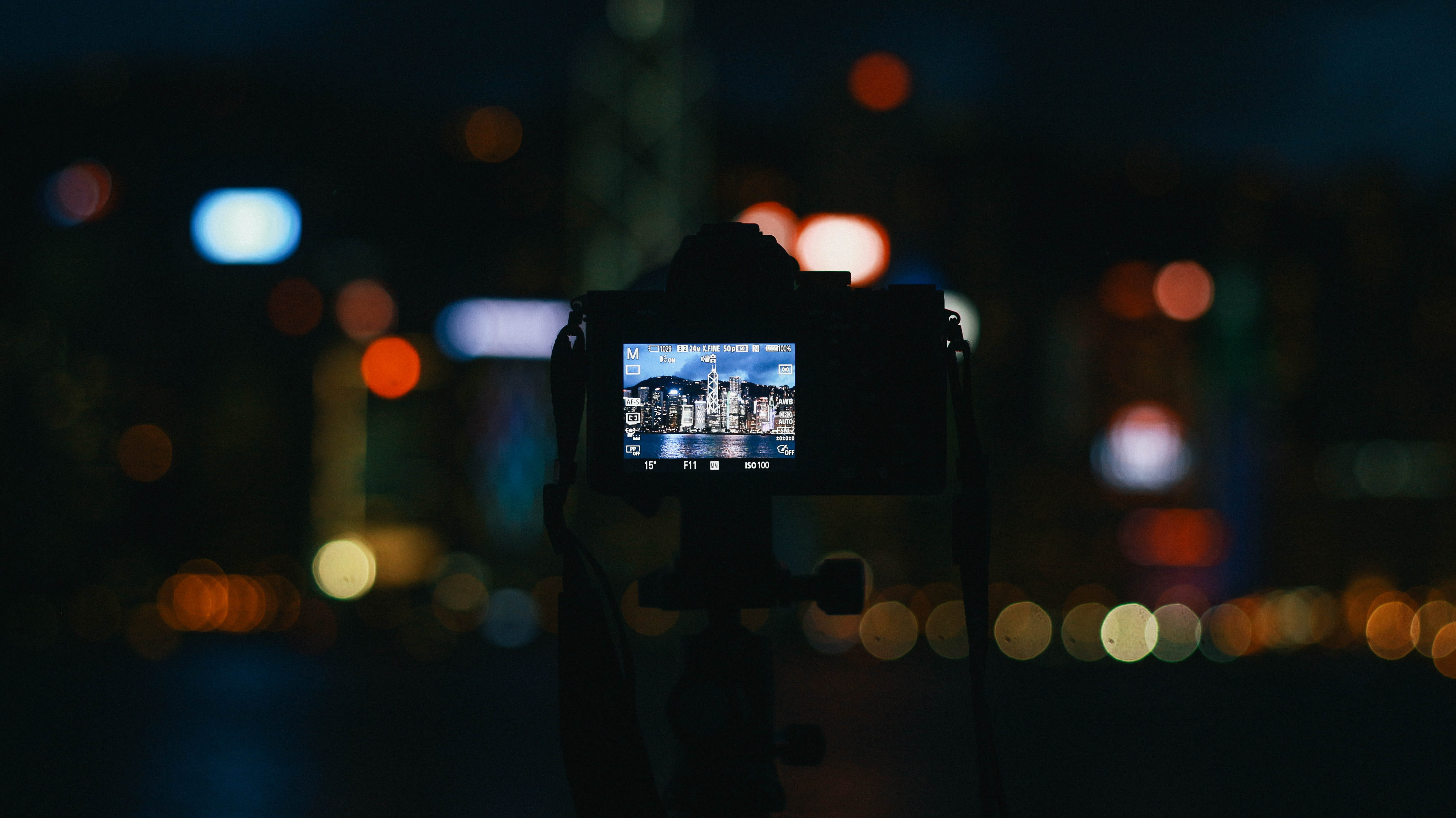 screen, tv, focus on foreground, filming, city, scoreboard, outdoors, led, monitor, electronics, digital viewfinder, photographic equipment, night, technology, HD Wallpaper