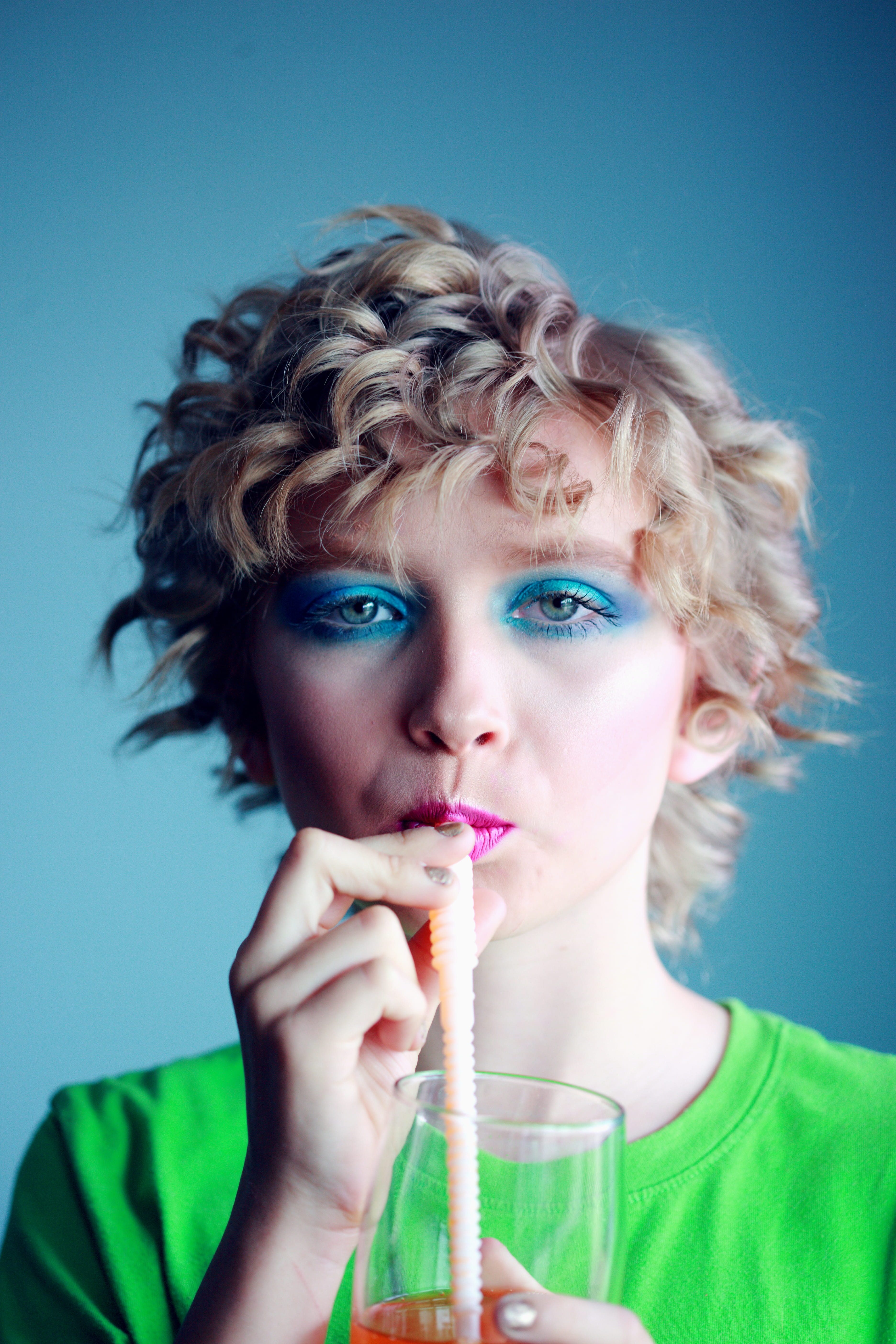 drinking straw, food and drink, sipping, indoors, one person, colored background, front view, woman, women, blue, beverage, headshot, glass, 5K, drinking, Phone HD Wallpaper