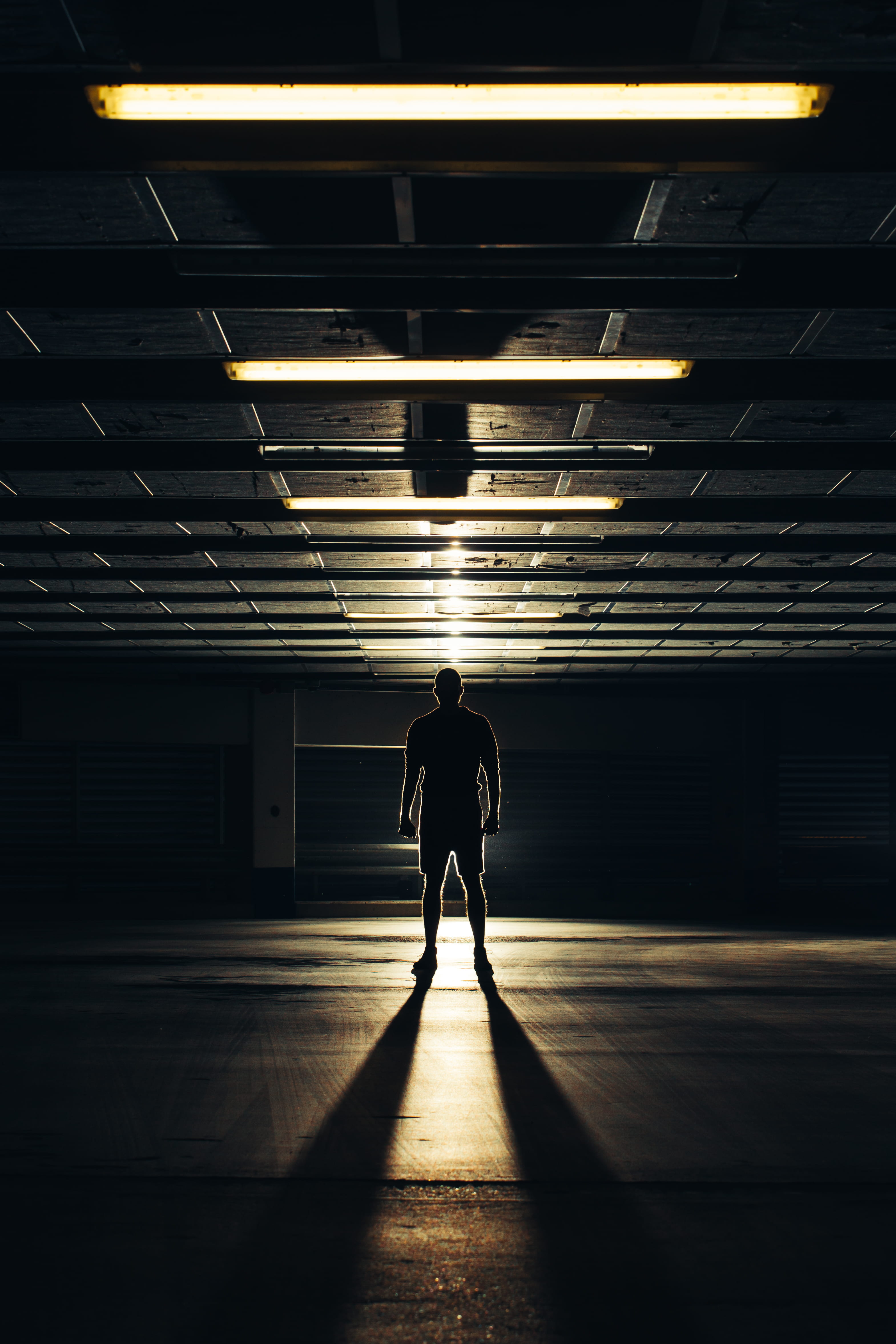 parking lot, leisure activity, robber, creepy, architecture, leading line, standing, full length, person, built structure, gate, real people, tunnel, silhouette, Phone HD Wallpaper
