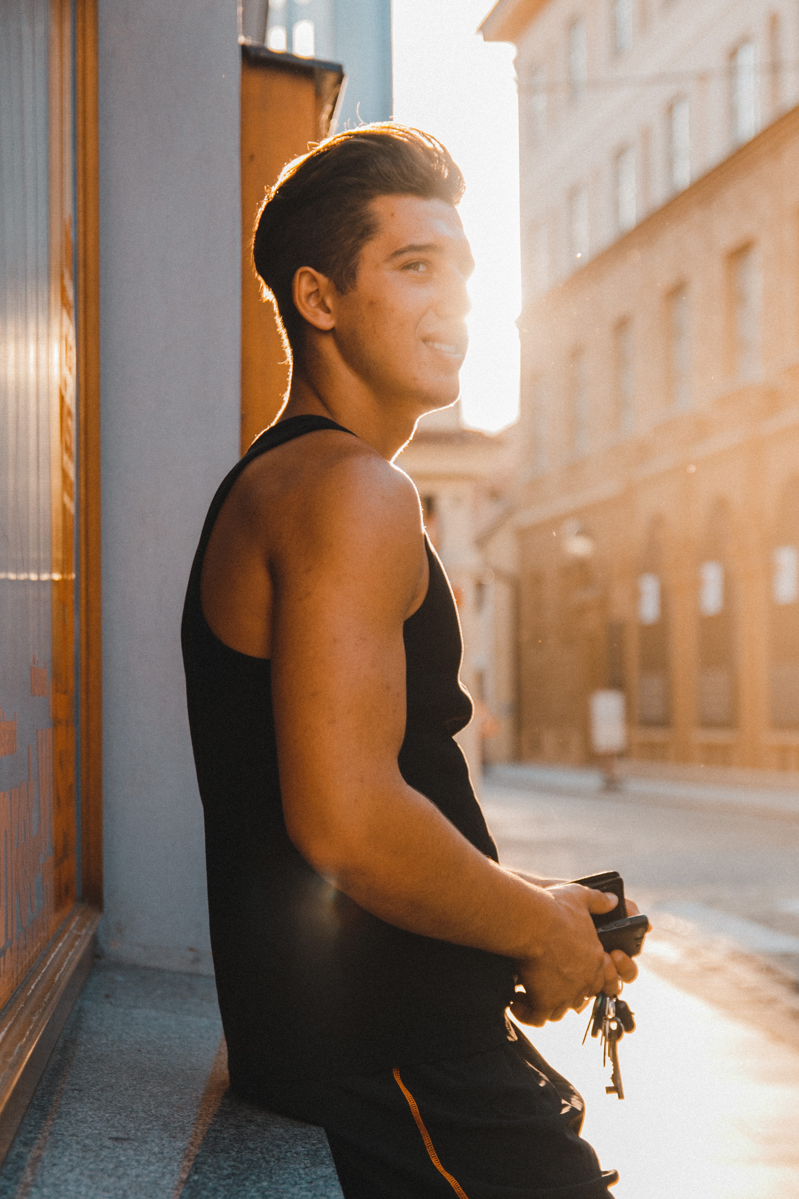 street, 4K, leisure activity, goldenhour, sunset, focus on foreground, man, gothic, near, leaning, guy, wearing, lens flare, downtown, sunlight, boy, streetphotography, Phone HD Wallpaper