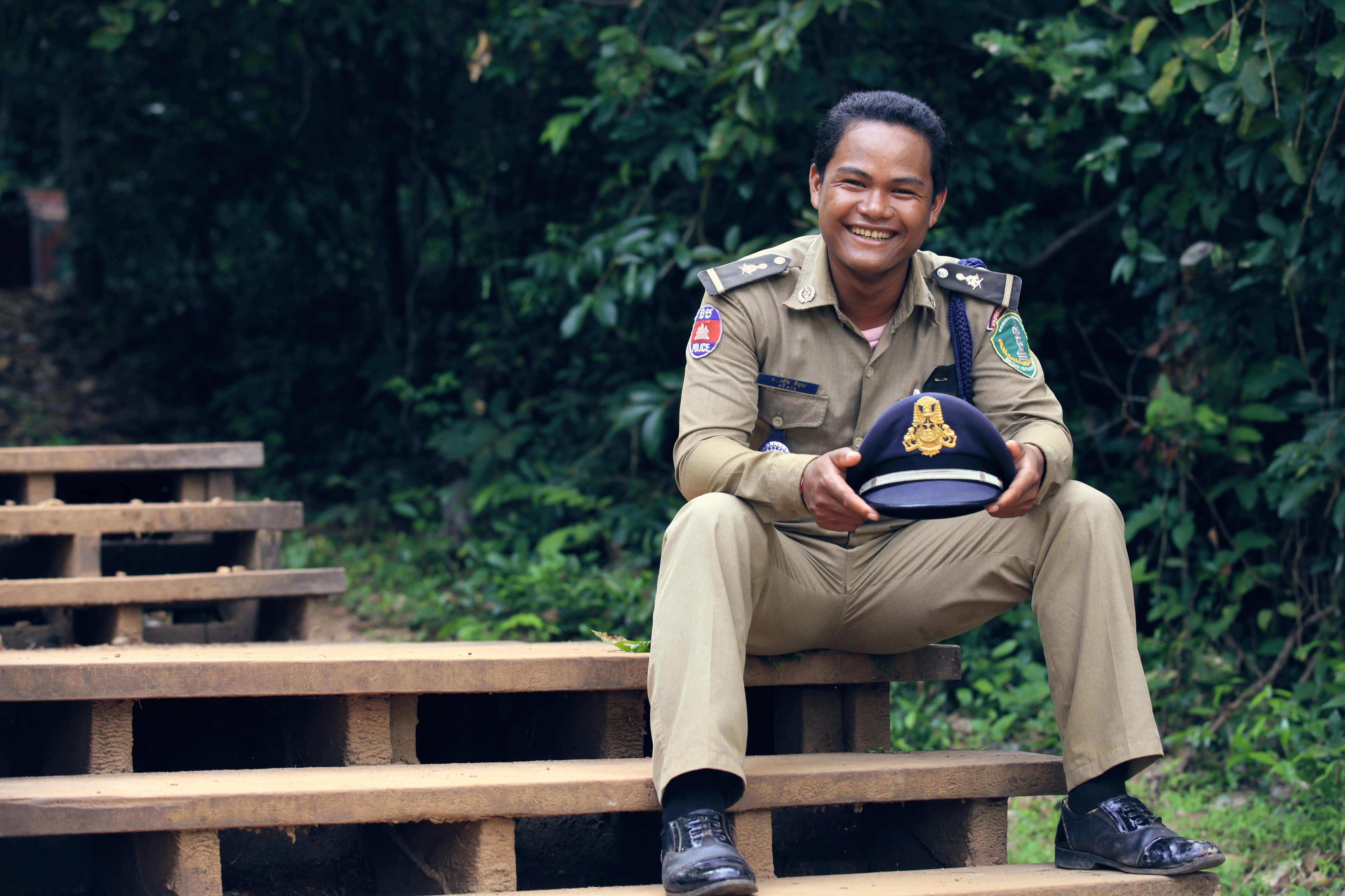 holding, security, indian, male, green, connection, cop, policeman, casual clothing, sheriff, looking at camera, sitting, young adult, real people, outdoors, HD Wallpaper