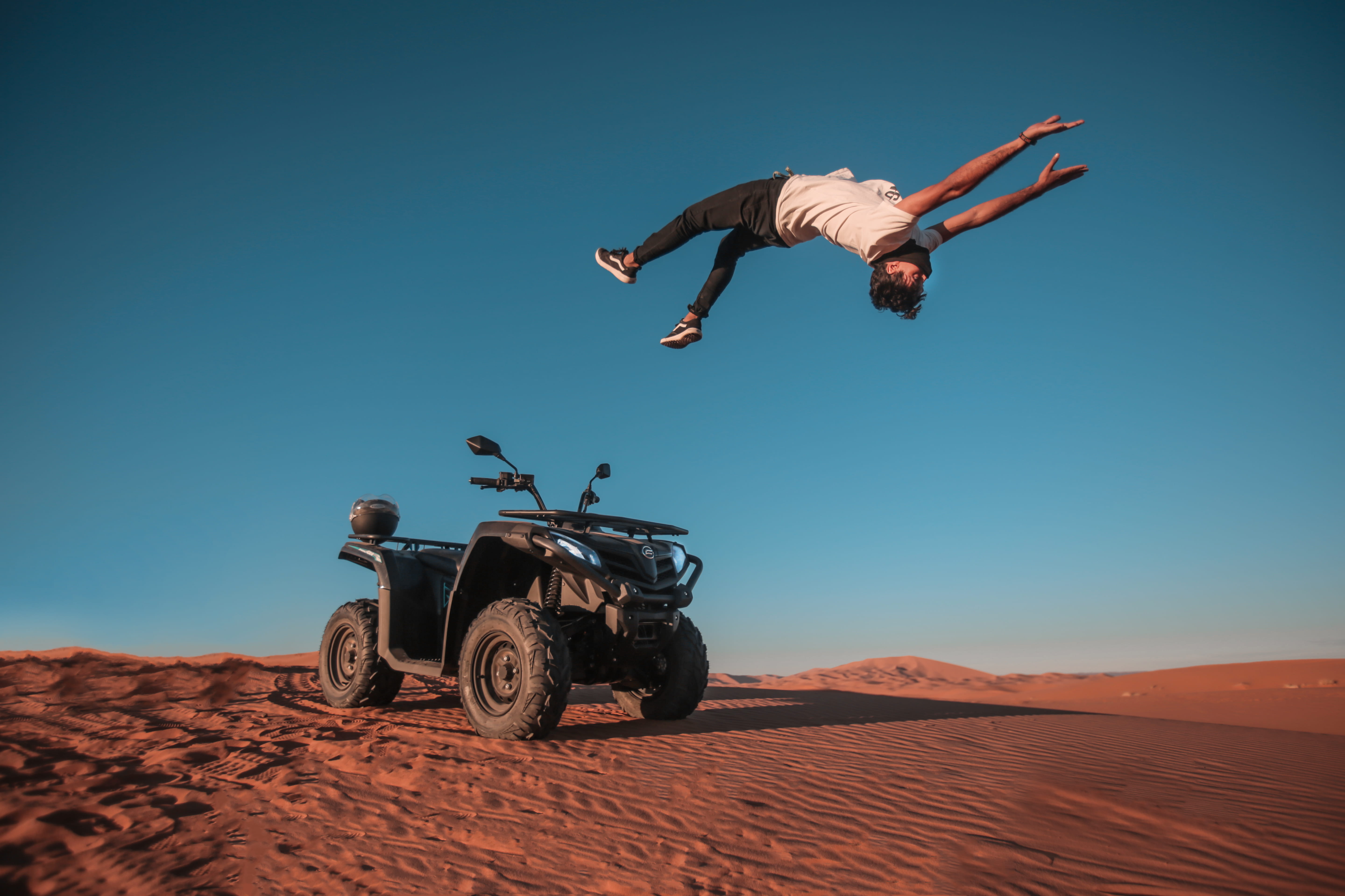 human arm, leisure activity, mid-air, leisure activities, 5K, adventure, clear sky, back flip, sunlight, sand, real people, arms raised, landscape, men, HD Wallpaper