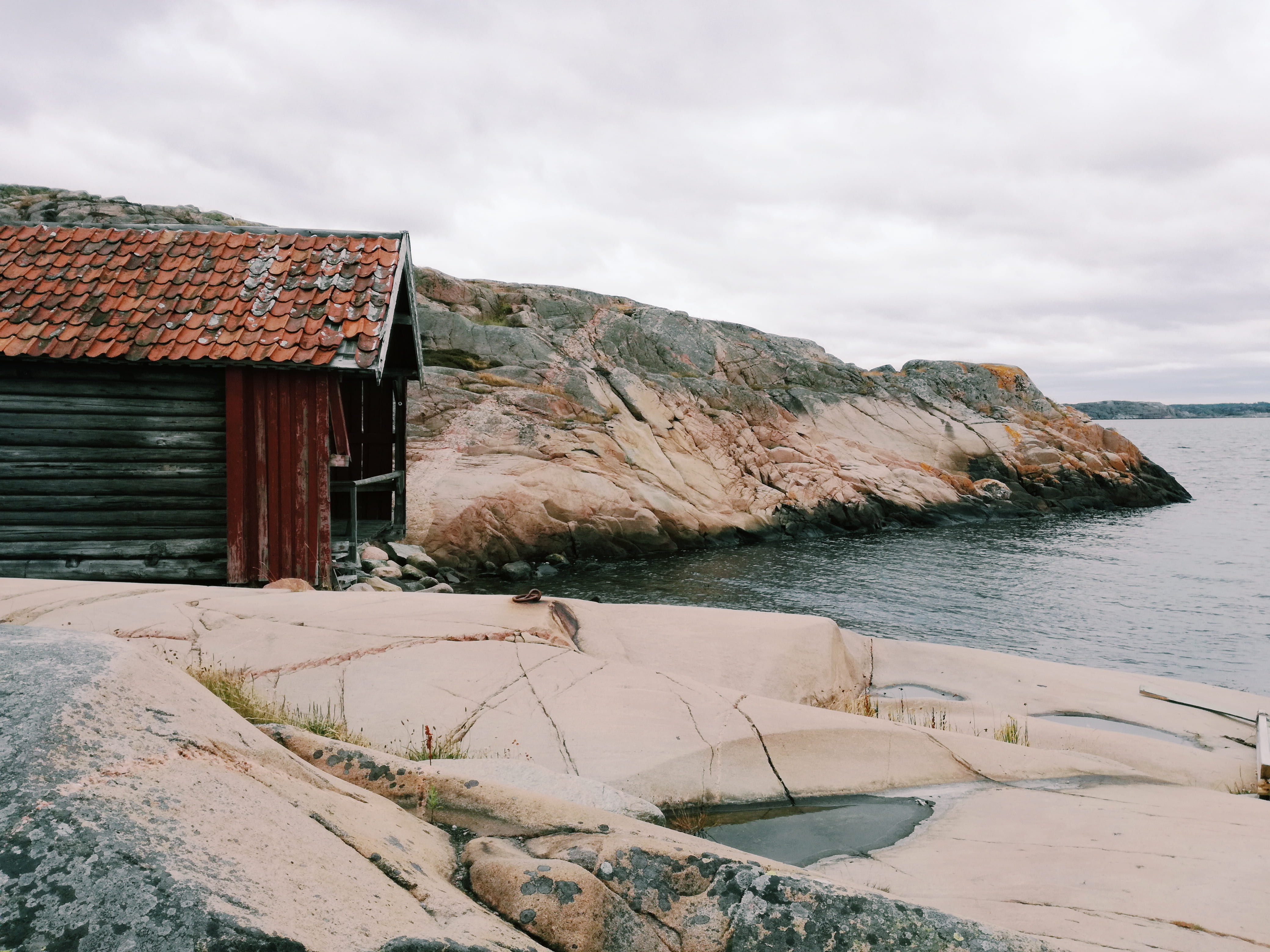 cliff, sky, mountain, cold temperature, brown, beside, building, building exterior, cabin, body, cloud - sky, boathouse, water, no people, sweden, scandinavian, HD Wallpaper