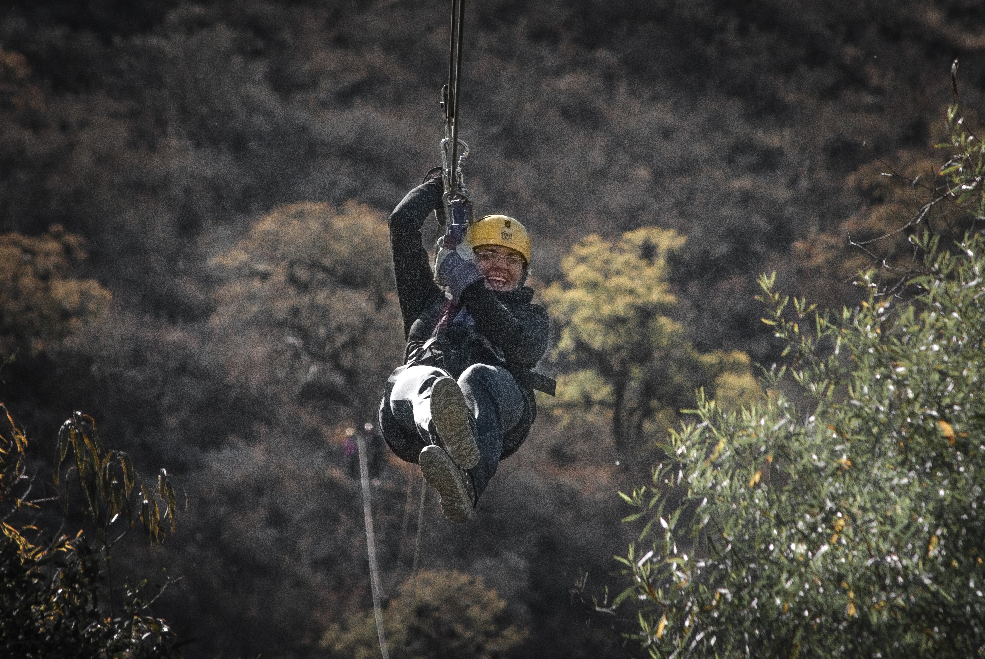 active, sport, safety, outdoors, 4K, daytime, zipline, holding, adventure, ziplining, wire, focus on foreground, day, riding, helmet, full length, entertainment, HD Wallpaper