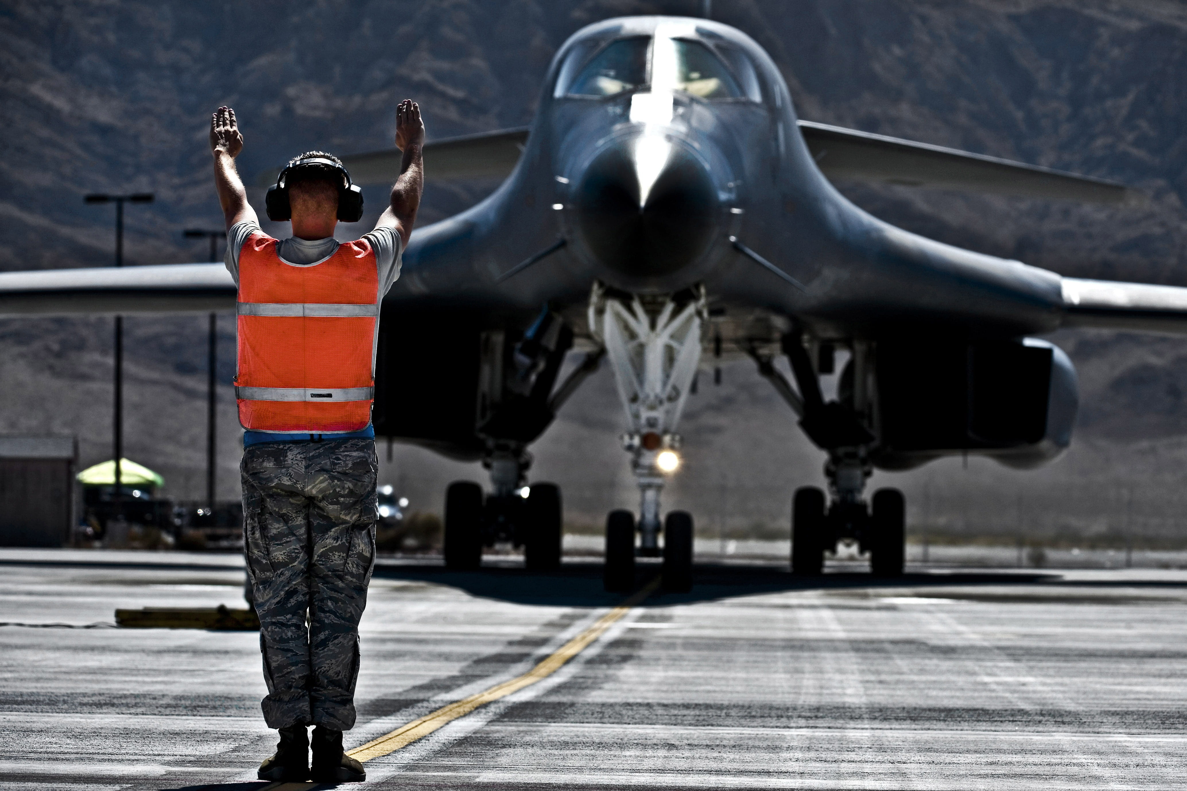 plane, air vehicle, base, clothing, aircraft, human arm, airport, body part, us air force, arms raised, uniform, rear view, human limb, b-1b lancer, transportation, HD Wallpaper