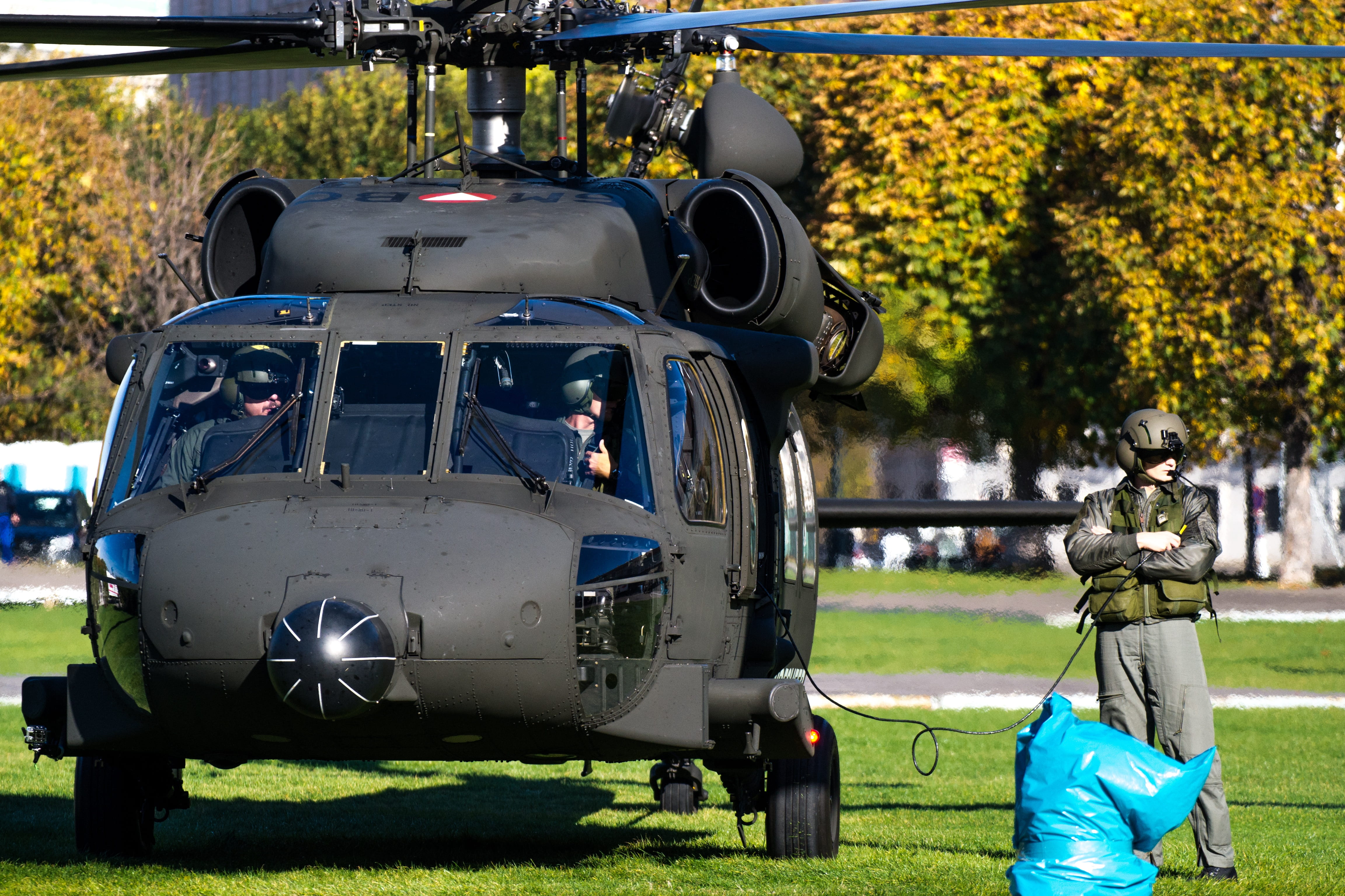 two people, field, grass, plant, land vehicle, transportation, bundeswehr, black hawk, tree, people, sunlight, real people, nature, outdoors, federal army, HD Wallpaper
