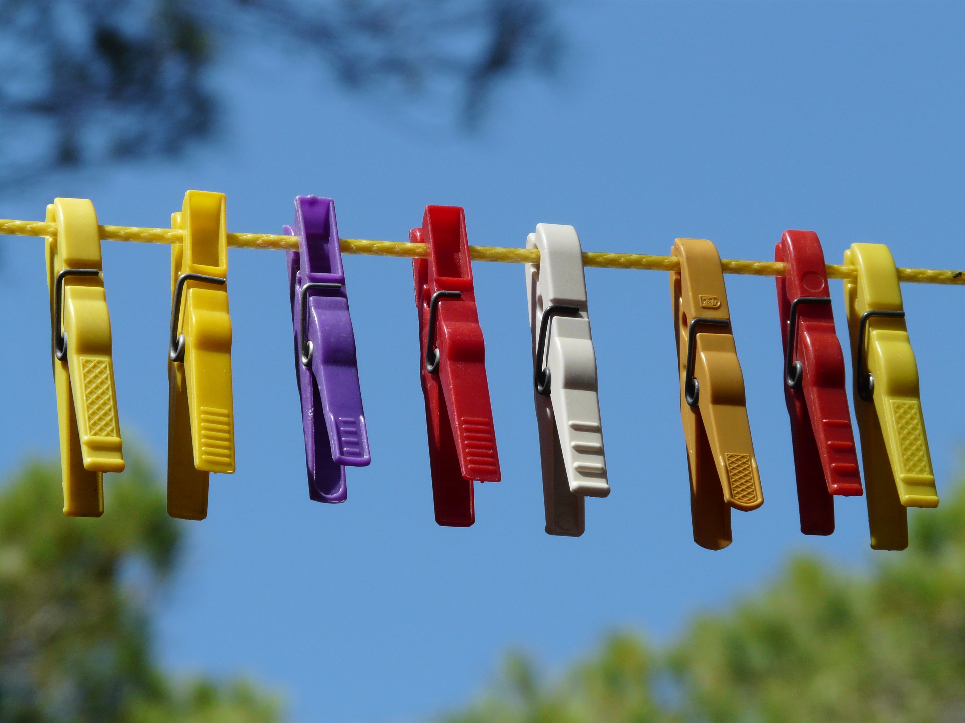 clothesline, in a row, out, sky, assorted, close-up, no people, dry, blue, side by side, outdoors, selective focus, multi colored, clothespin, clothespins, HD Wallpaper