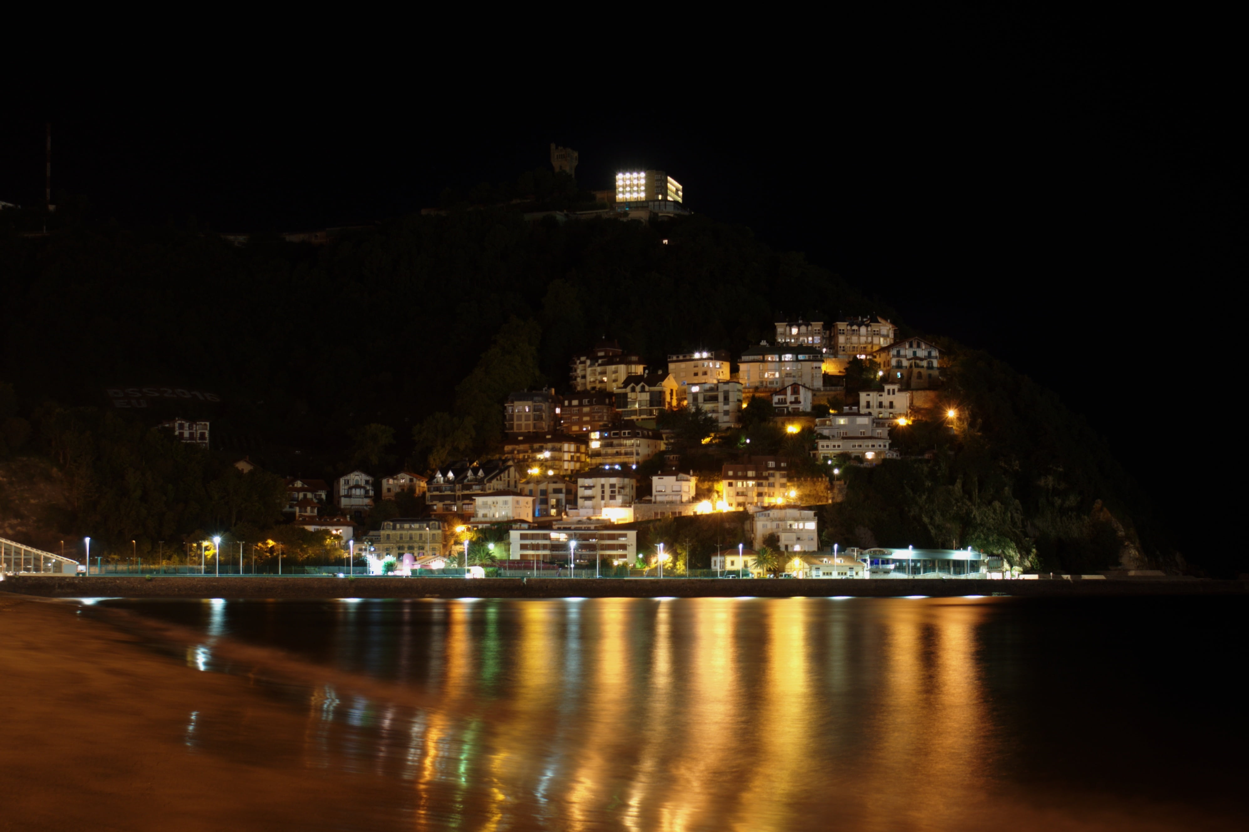 night landscape, illuminated, waterfront, outdoors, 4K, water, light, reflection, place of worship, no people, san sebastian, religion, belief, night, HD Wallpaper