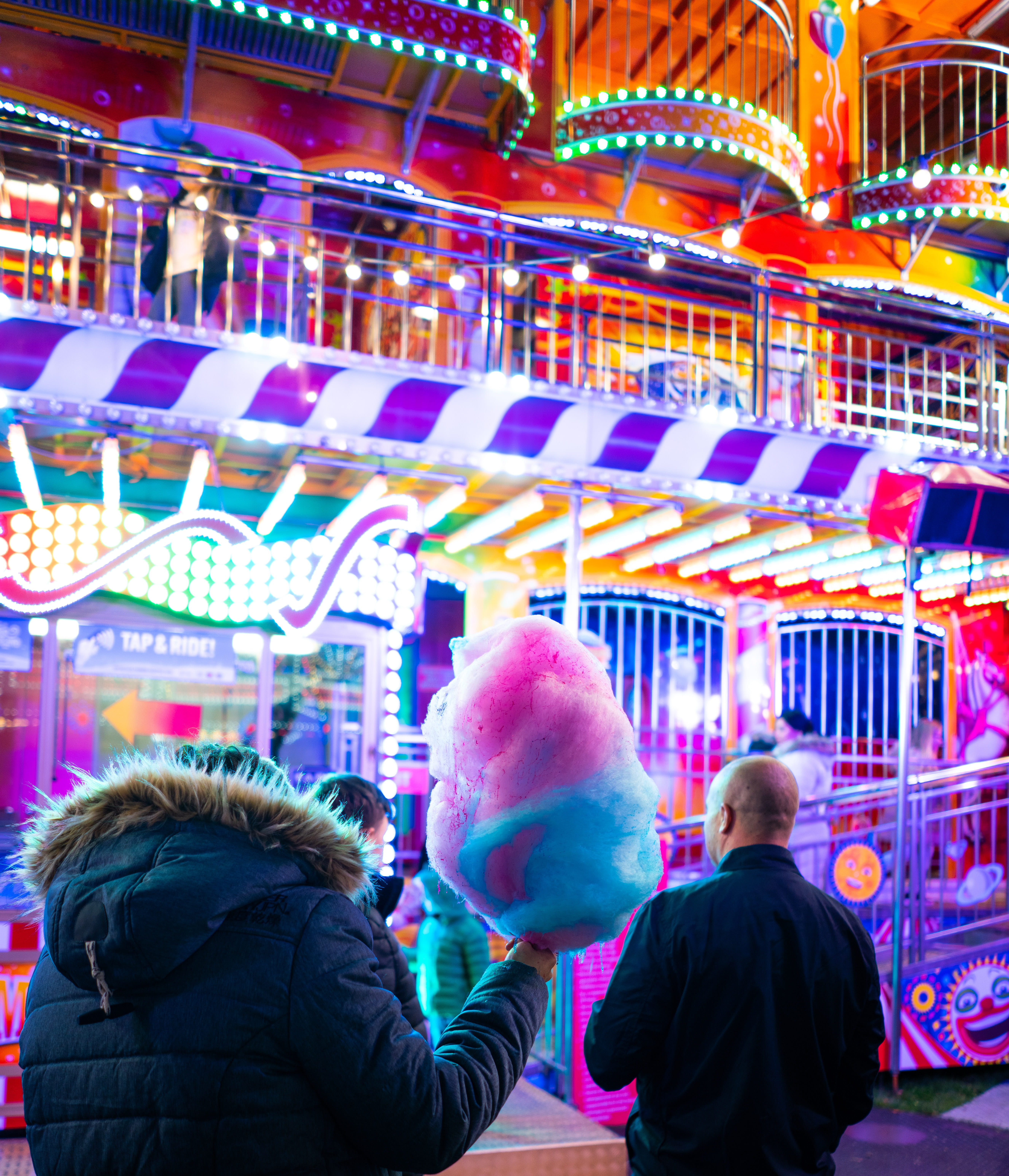 cotton, adult, indoors, pink, person, holding, overcoat, festival, group of people, illuminated, fun, theme park, warm clothing, built structure, leisure activity, Phone HD Wallpaper