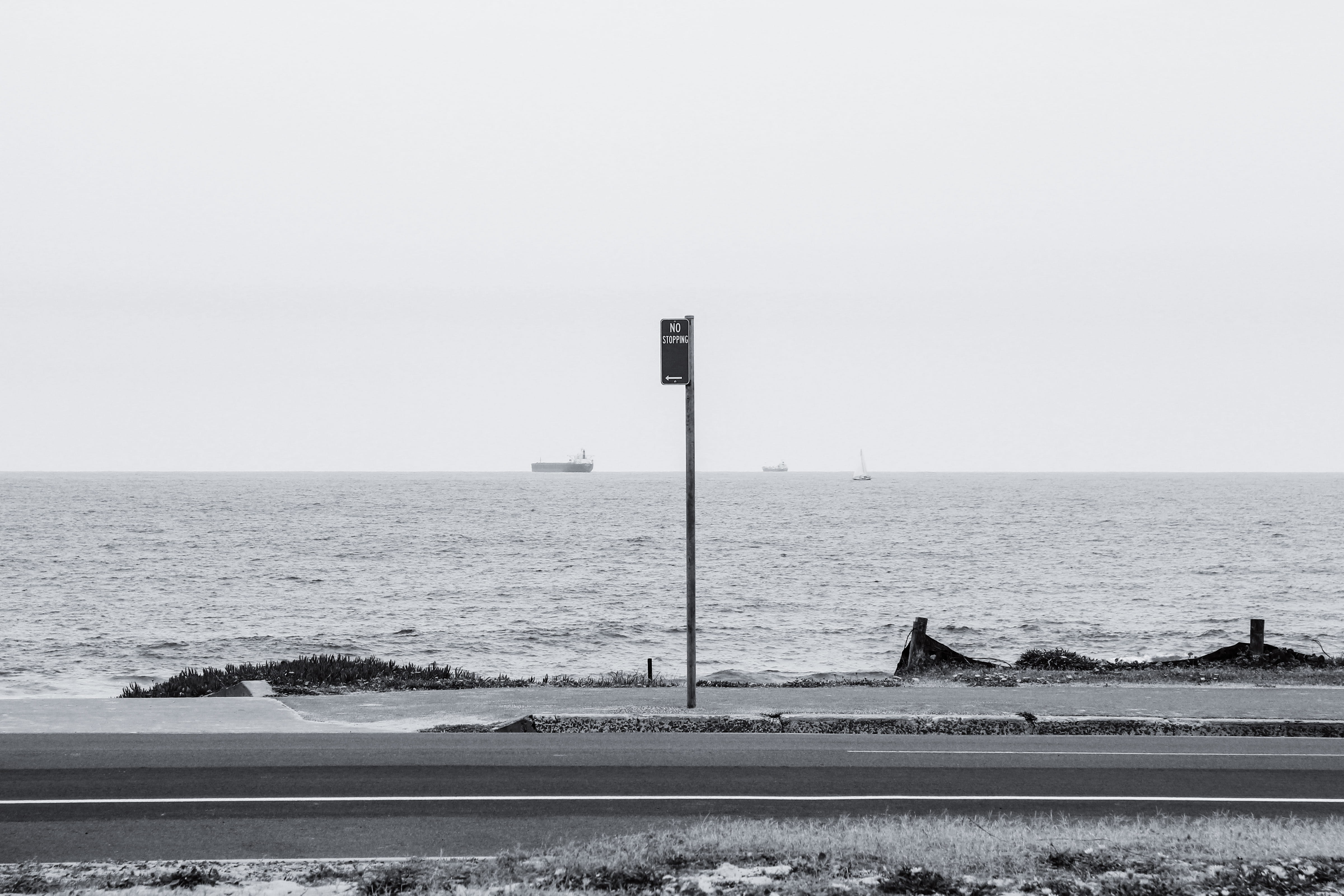 beach, ocean, seaside, sky, minimal, coast, sea, tranquility, land, outdoors, 4K, sign, tranquil scene, nature, white, street light, ships, water, horizon, HD Wallpaper