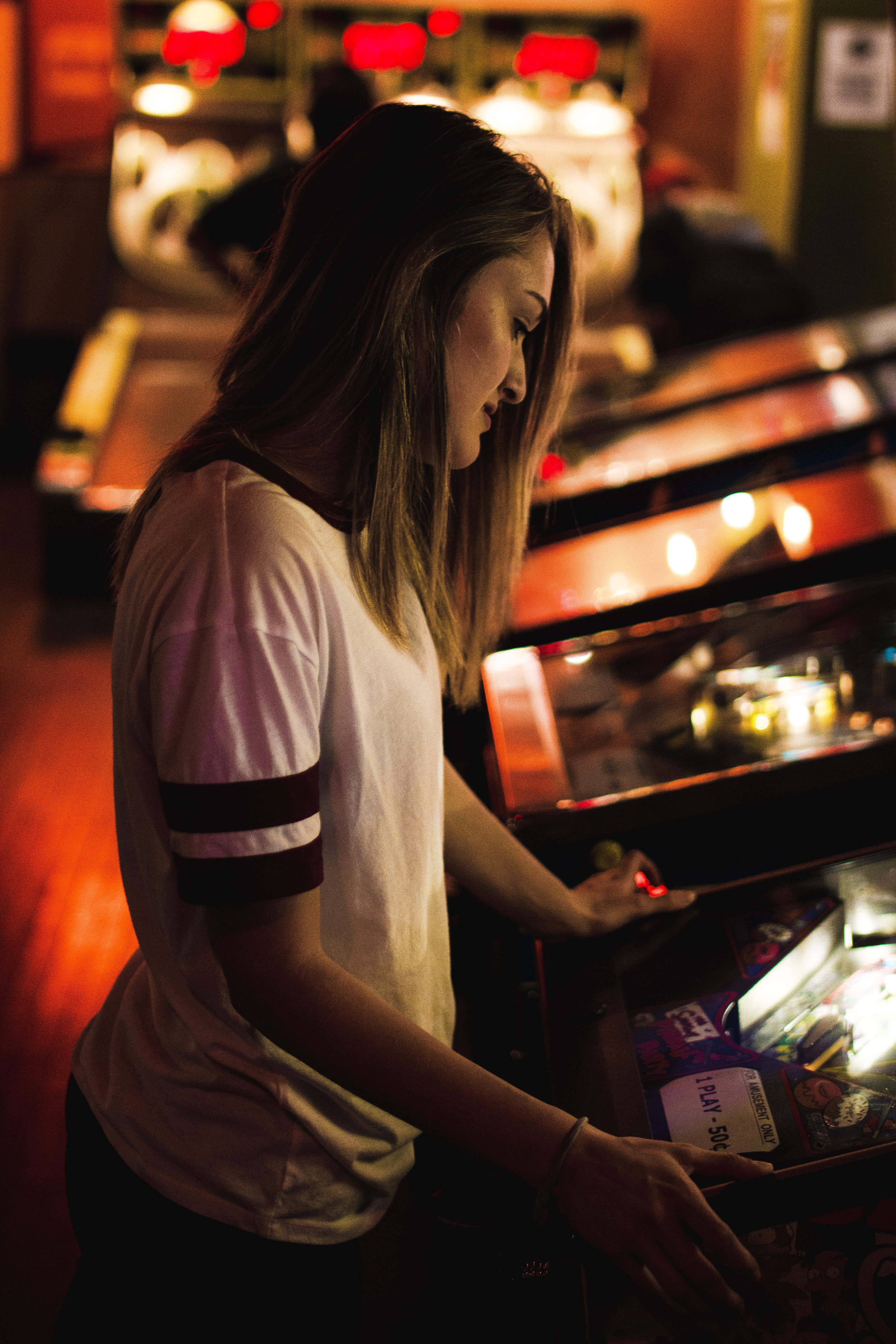 arcade, sitting, innocence, night, girls, women, lady, game, child, indoors, gambling, black, brunette, 5K, girl, childhood, female, play, casino, leisure activity, Phone HD Wallpaper