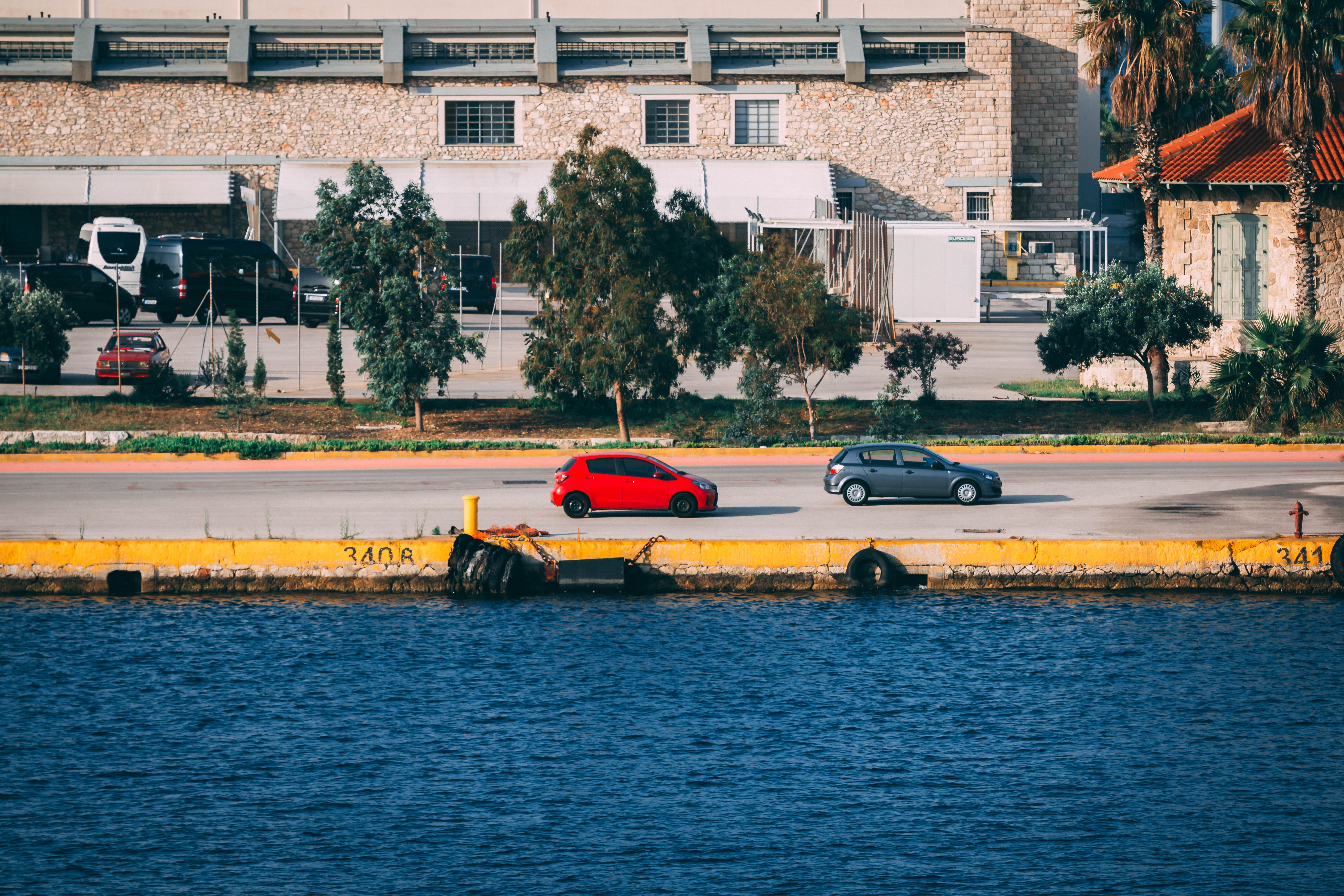 motion, land vehicle, city, no people, built structure, motor vehicle, side, hatchbacks, vehicles, car, r, trees, wate, street, plant, building, waterfront, HD Wallpaper