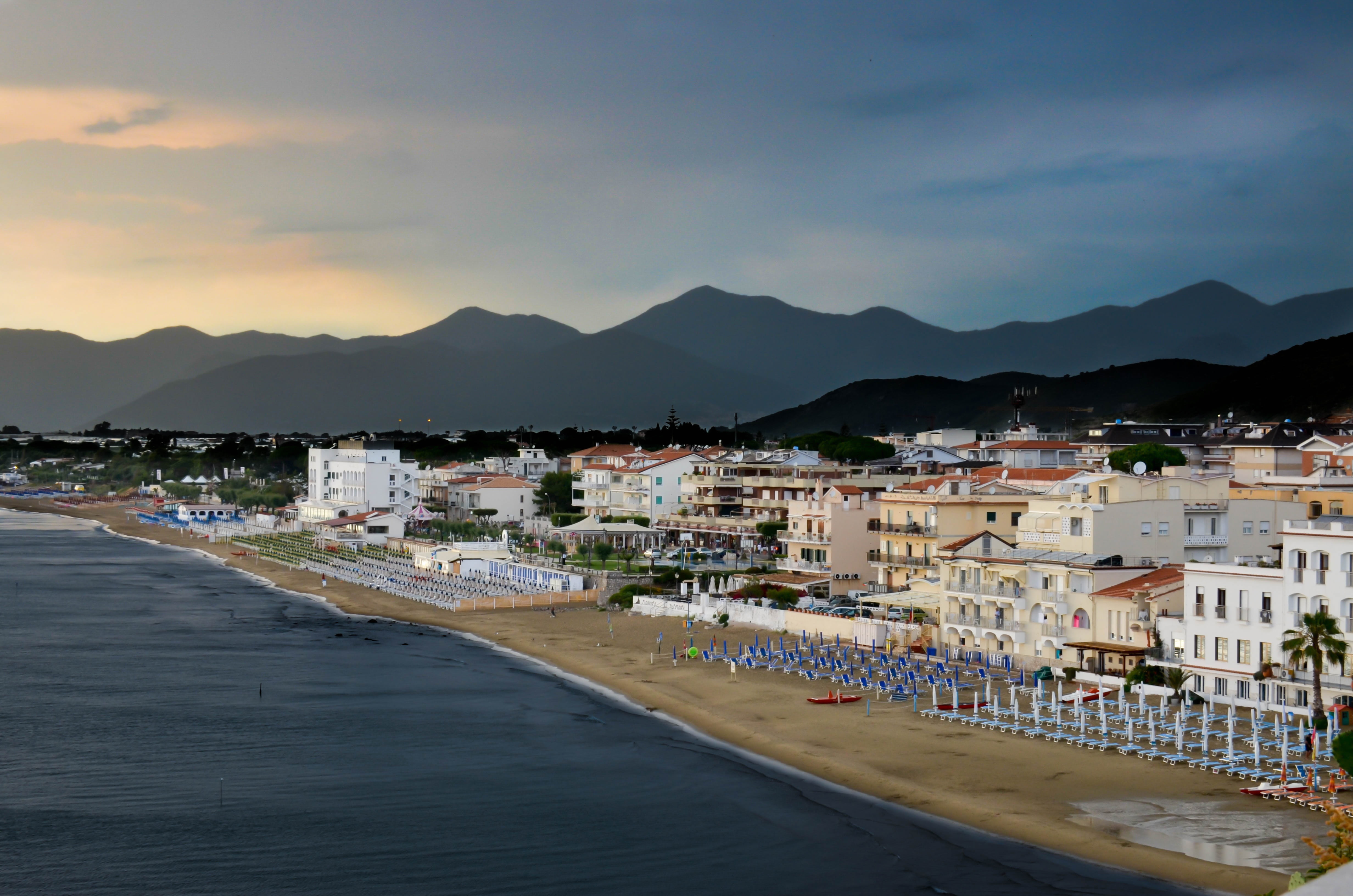 seaside, mountain, holiday, no people, italy, house, 4K, water, sea, beachfront, mountain range, town, sky, vacation, cityscape, building exterior, building, HD Wallpaper