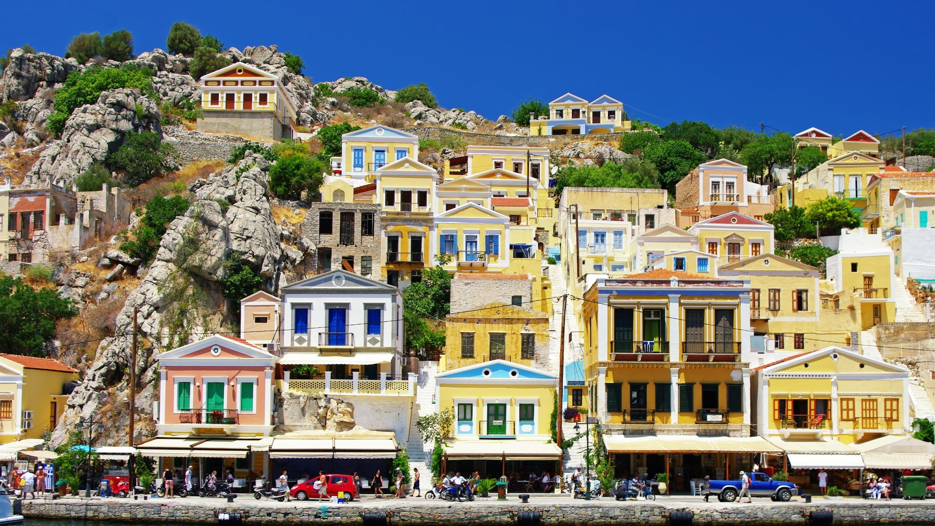city, sunlight, large group of people, mountain, 1080P, architecture, outdoors, Symi, built structure, group of people, day, clear sky, nature, building exterior, HD Wallpaper