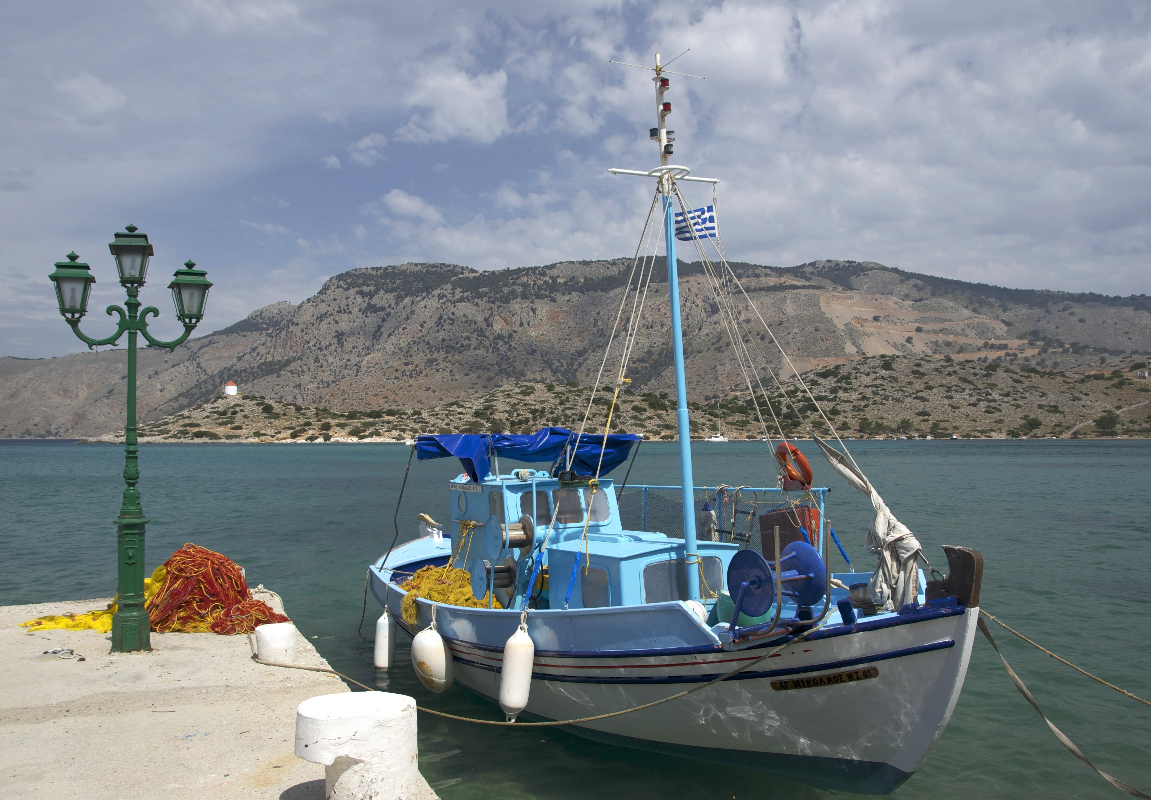 harbor, fishing boat, dock, mountain, boat, port, flag, nature, sky, mountain range, outdoors, transportation, 4K, pole, travel, scenic, symi, sailboat, HD Wallpaper