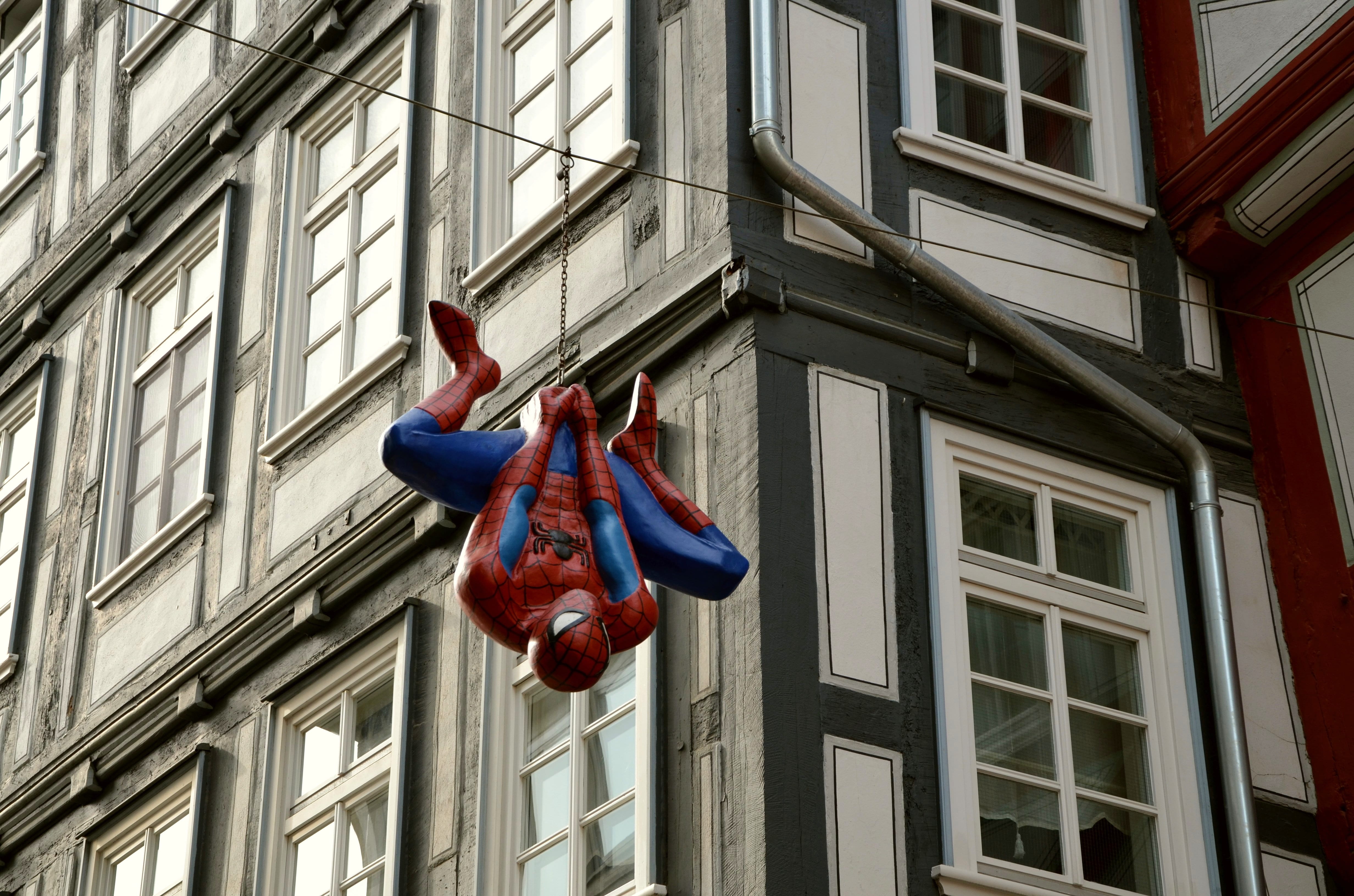 day, blue, outdoors, daytime, cartoon character, pedestrian zone, man, art and craft, city, spiderman, architecture, street, hanging, decor, built structure, HD Wallpaper