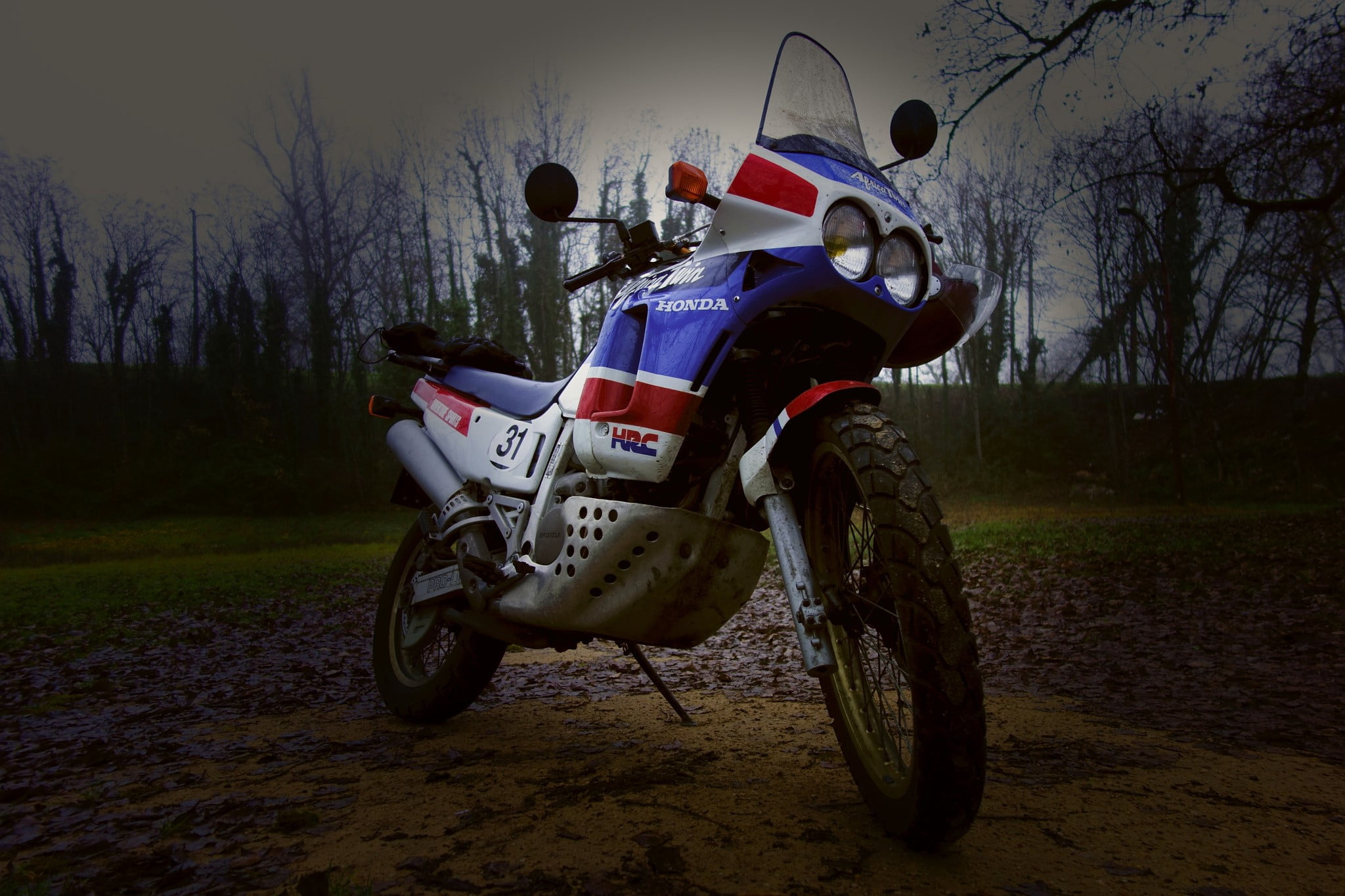 crash helmet, transportation, outdoors, sports helmet, 1080P, land, dirt, Honda Africa Twin, bare tree, sky, plant, mode of transportation, wheel, one person, HD Wallpaper