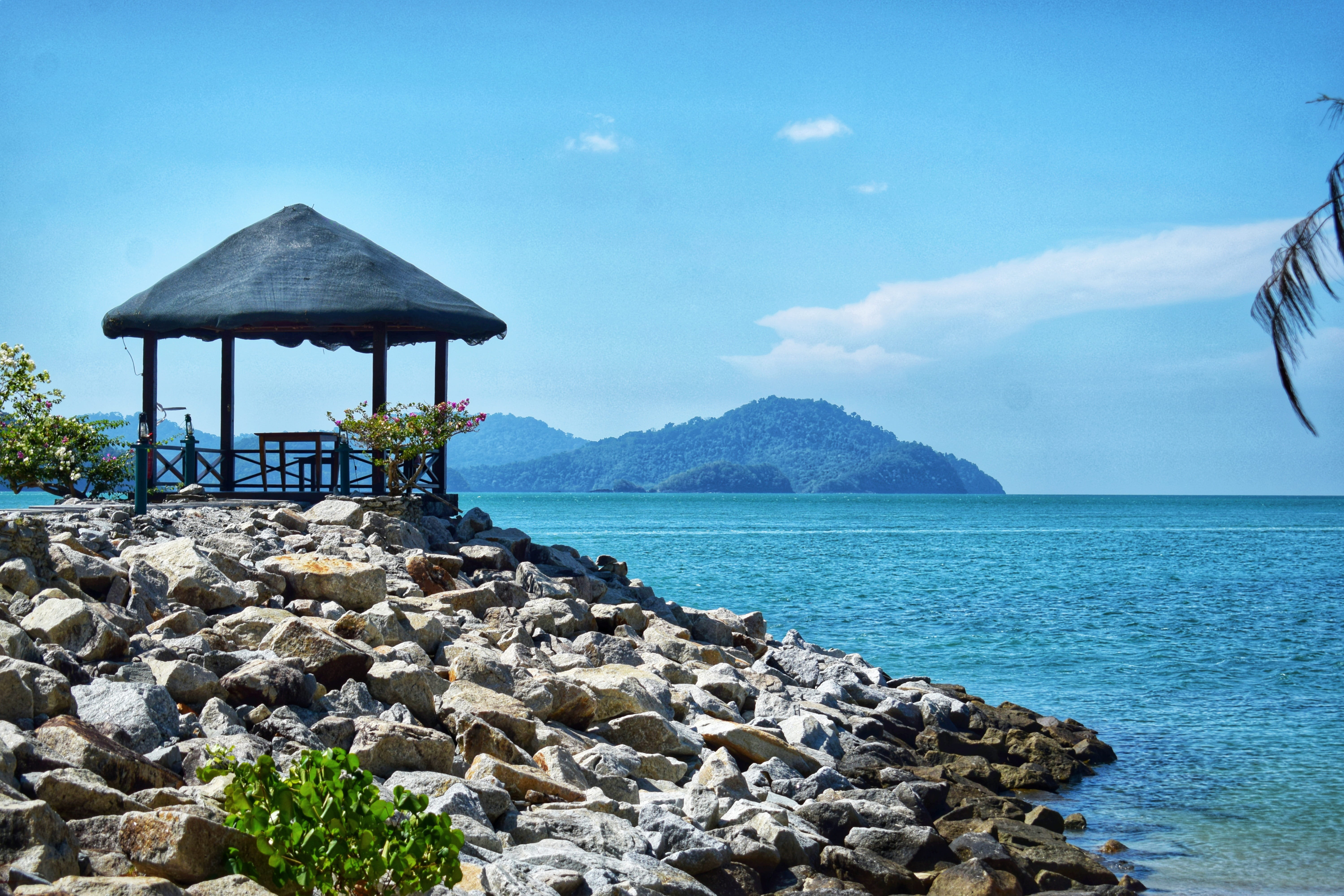 built structure, 5K, sky, outdoors, architecture, beach, tranquility, day, scenics - nature, rock - object, mountain, horizon, pebbles, nature, sea, langkawi, HD Wallpaper