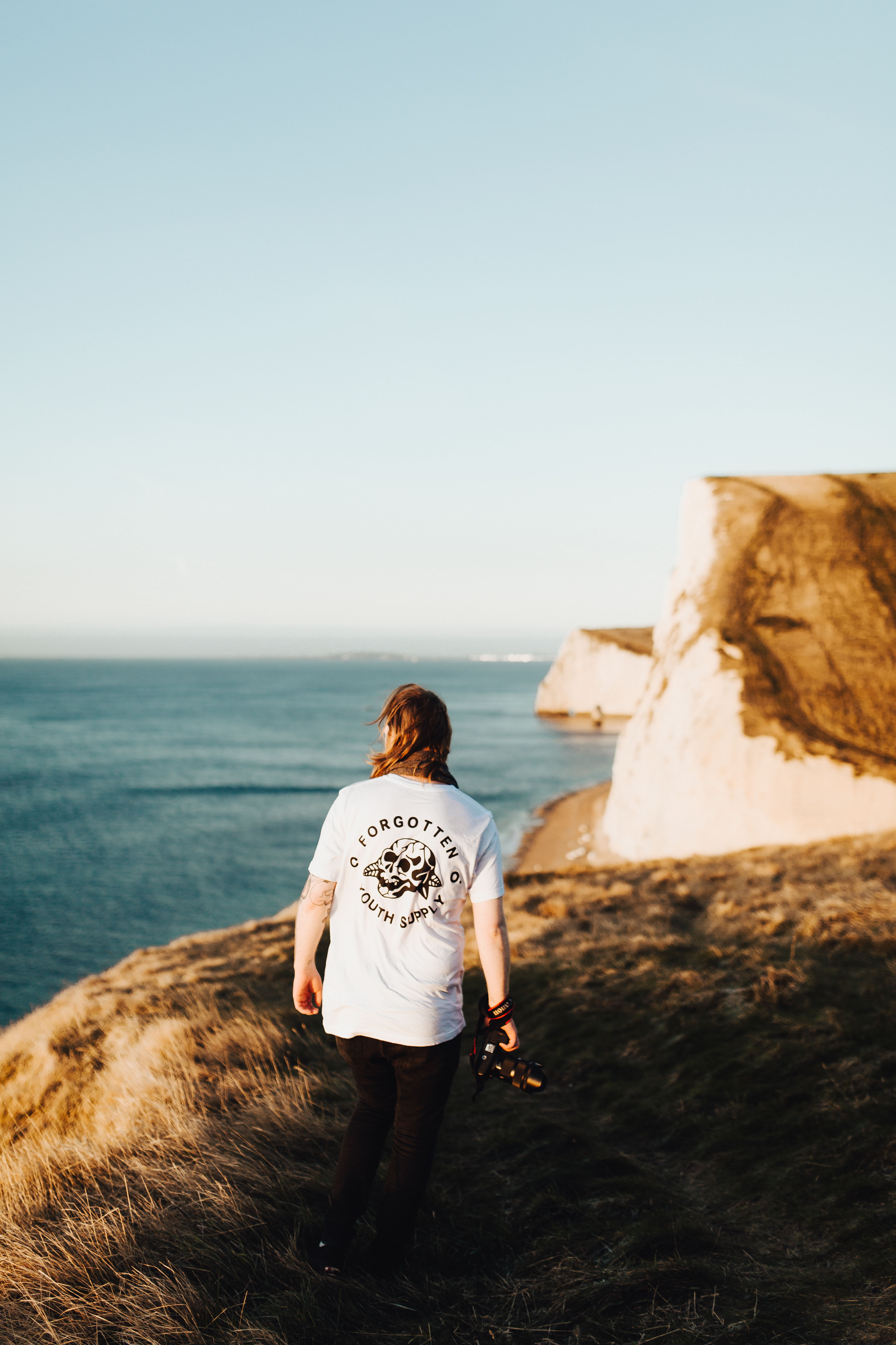 rock - Object, sand, pets, person, casual clothing, waves, cliff, one animal, females, horizon over water, rock, domestic, adult, water, alone, near, one Person, Phone HD Wallpaper