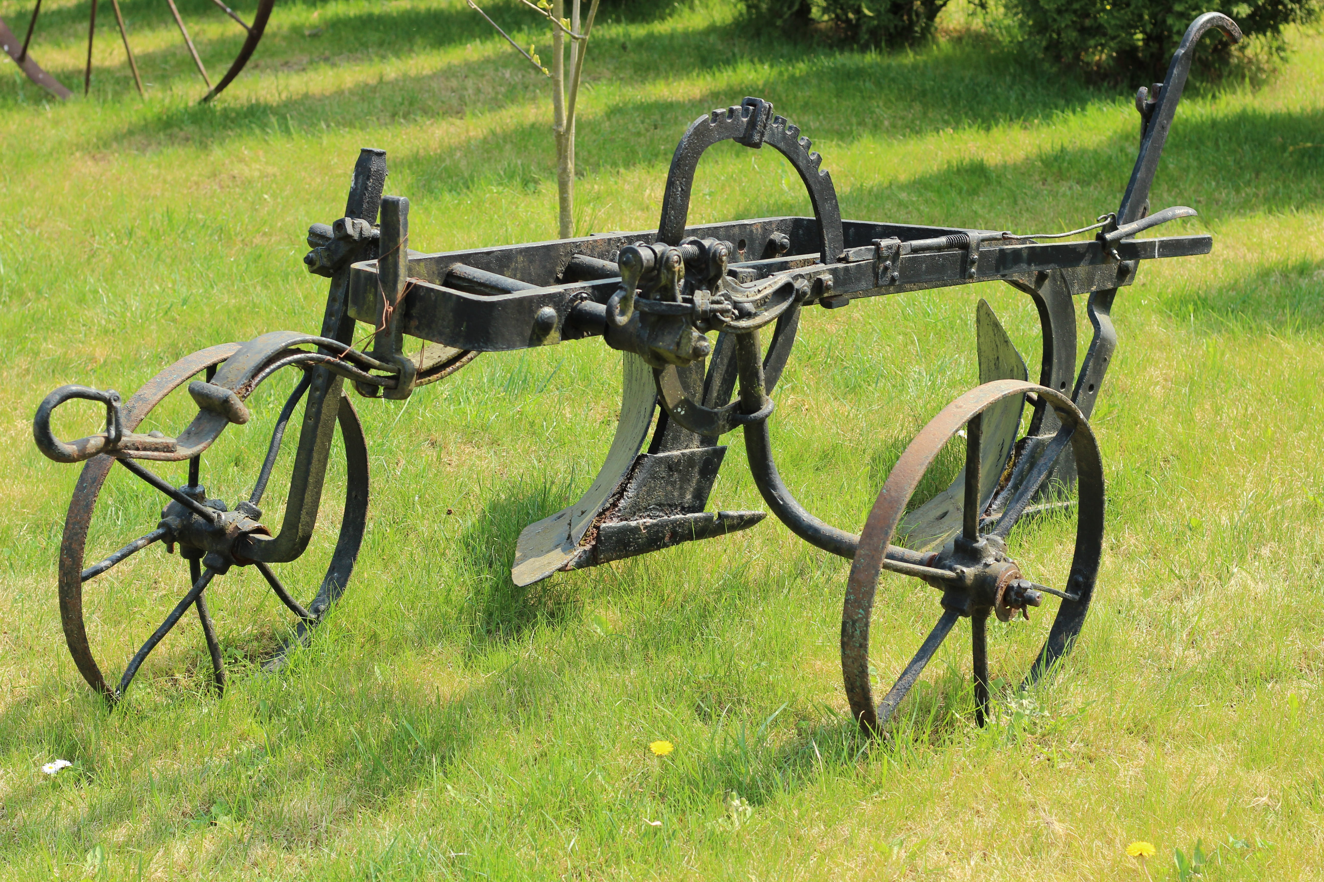 park - man made space, metal, plant, machinery, mounted, grass, old, wheel, 5K, park, plow, agricultural, green color, growth, transportation, field, sunlight, HD Wallpaper