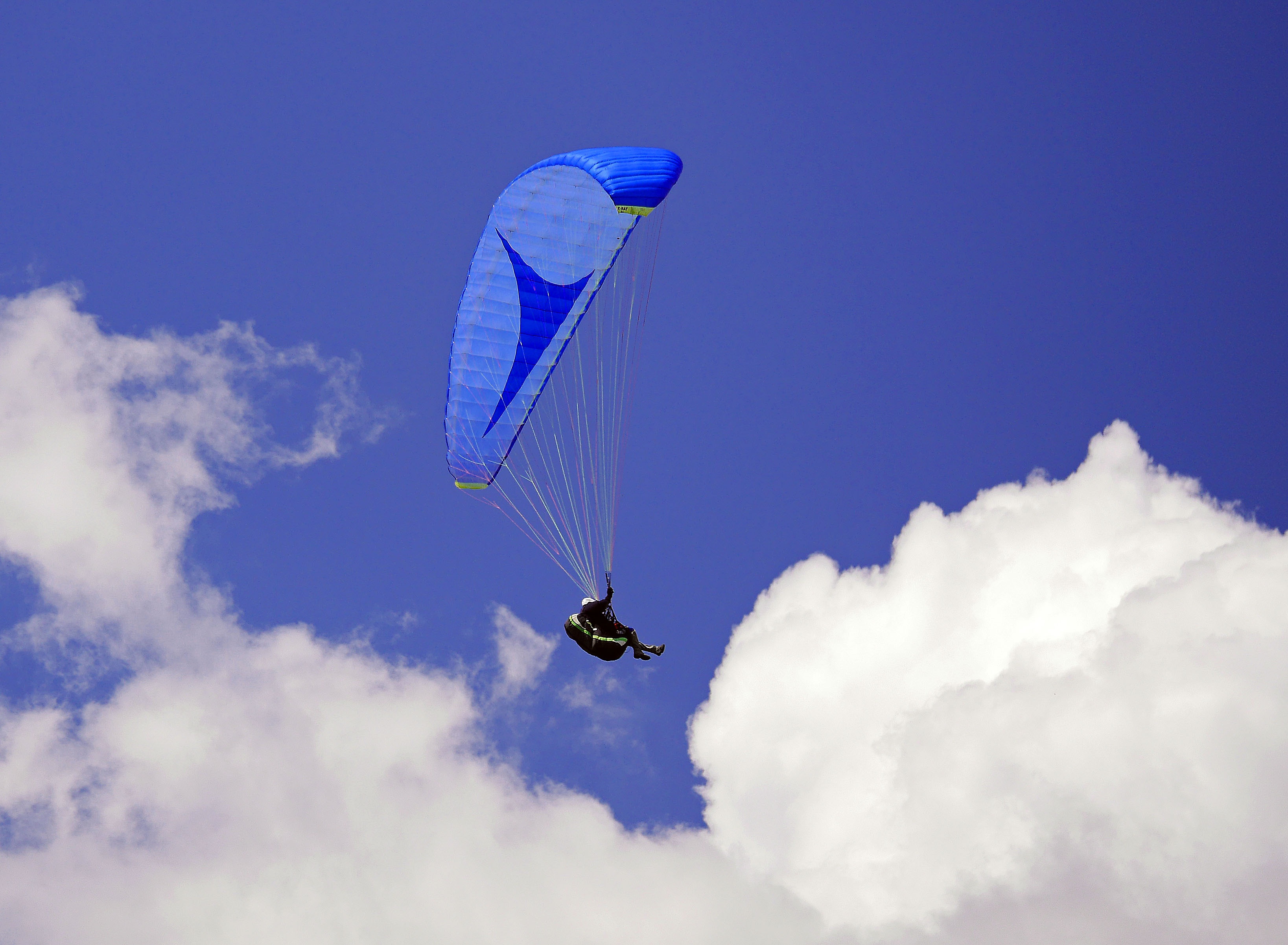 gliding, flying, sky, parasailing, suspension wires, outdoors, freedom, blue-in-blue, mid-air, one person, sport, ozone, leisure activity, 2K, blue, real people, HD Wallpaper