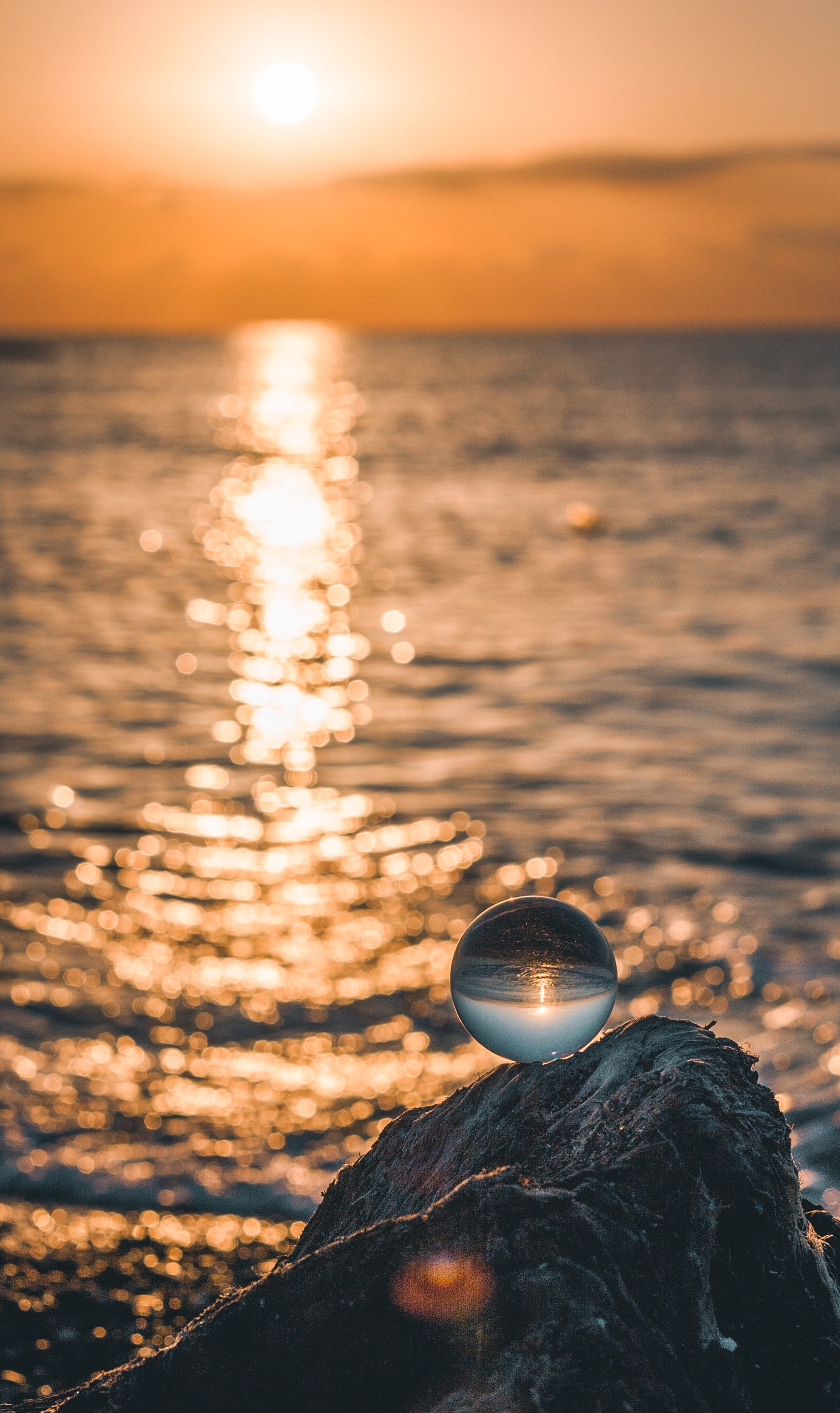 wall, no People, wave, seashore, dusk, love, reflection, 2K, yellow, backgrounds, photo, coastline, beach, rock - Object, shiny, rocky, bright, glass ball, Phone HD Wallpaper