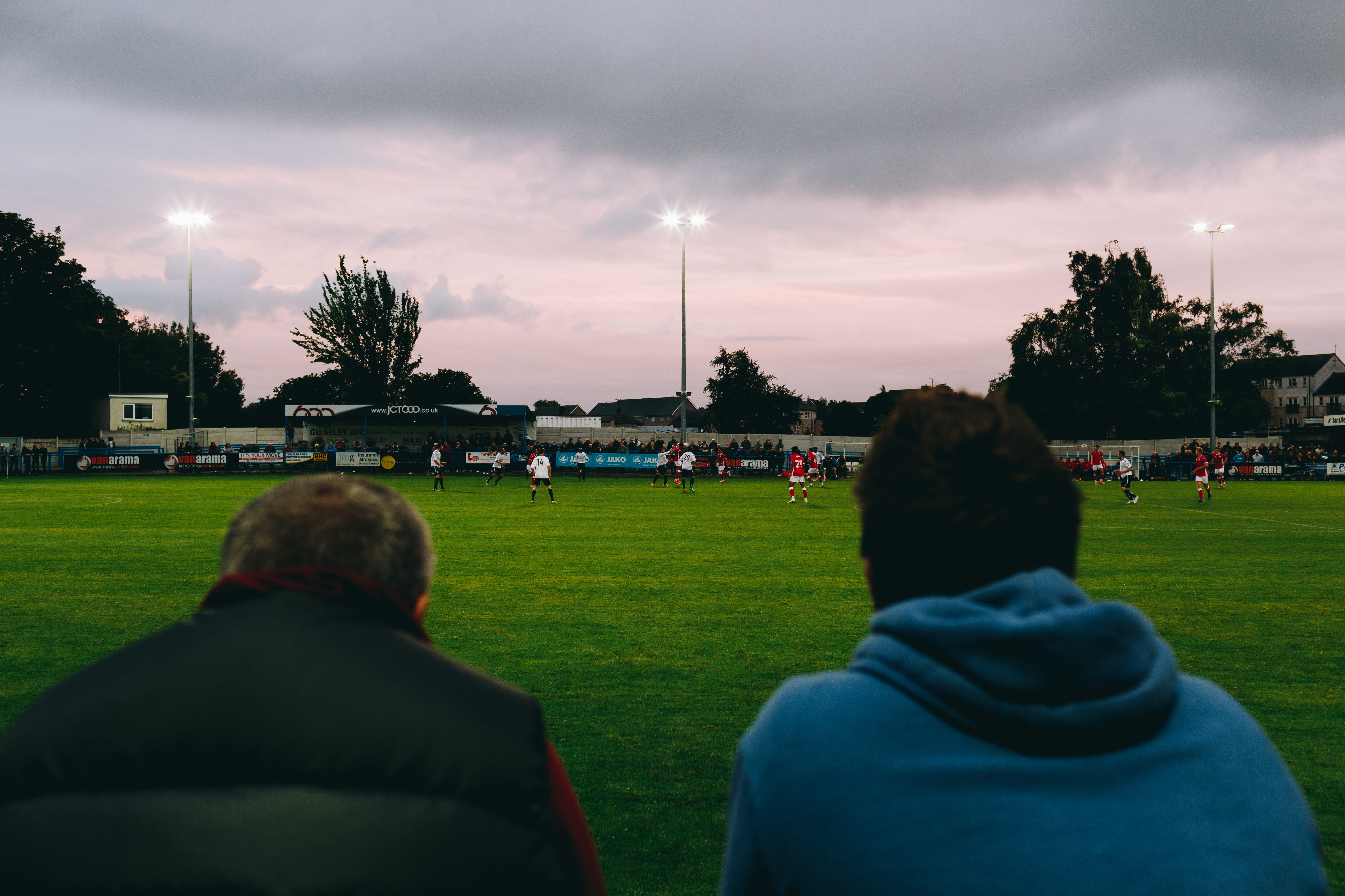 football, group of people, stadium, culture, hoodie, grass, lifestyles, sport, guiseley, tree, field, cloud - sky, sitting, betting, floodlights, leisure activity, HD Wallpaper