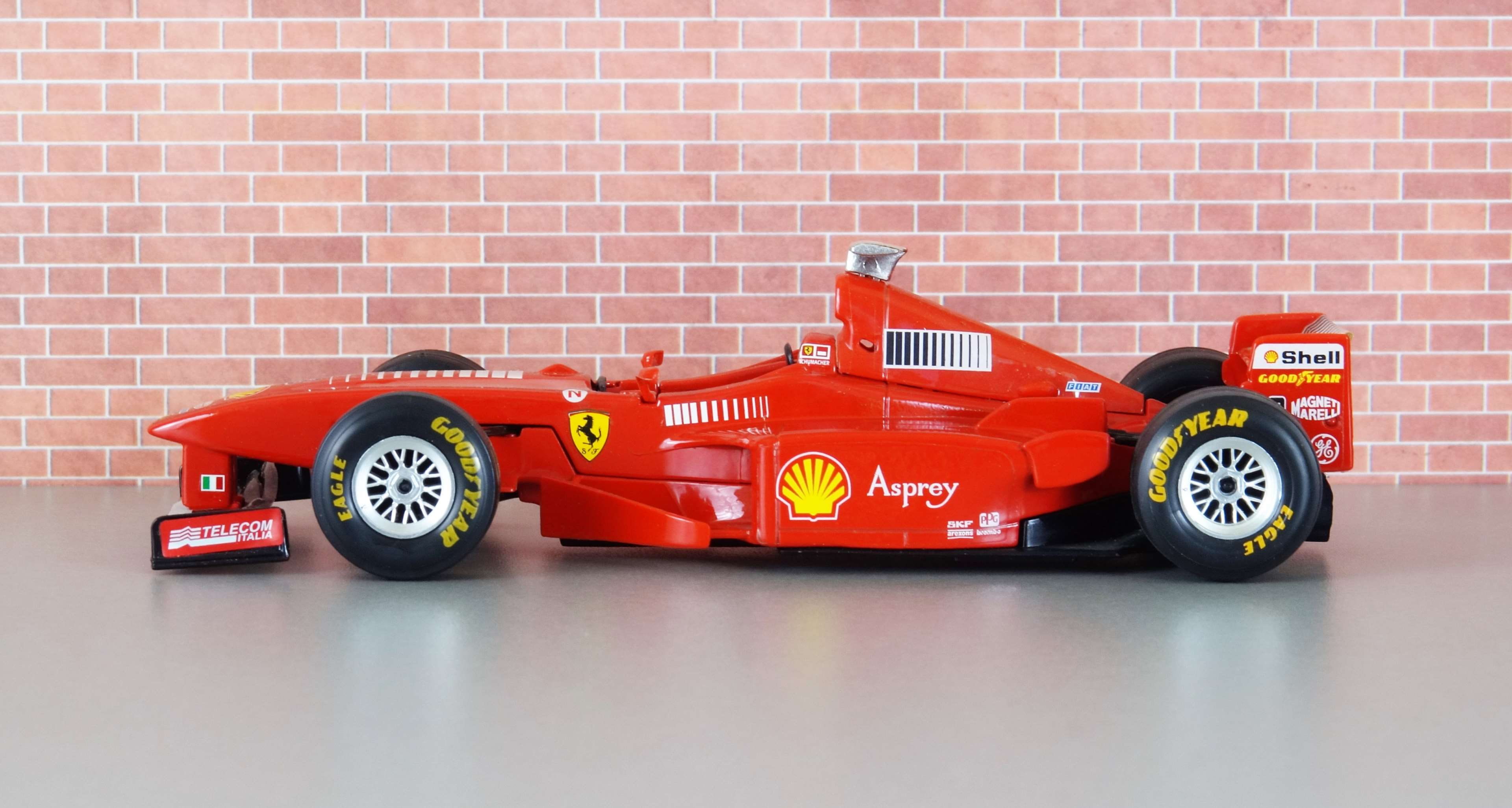 toys, michael schumacher, brick wall, racecar, architecture, brick, speed, toy, toy car, copy space, car, red, motor vehicle, vehicles, indoors, success, HD Wallpaper