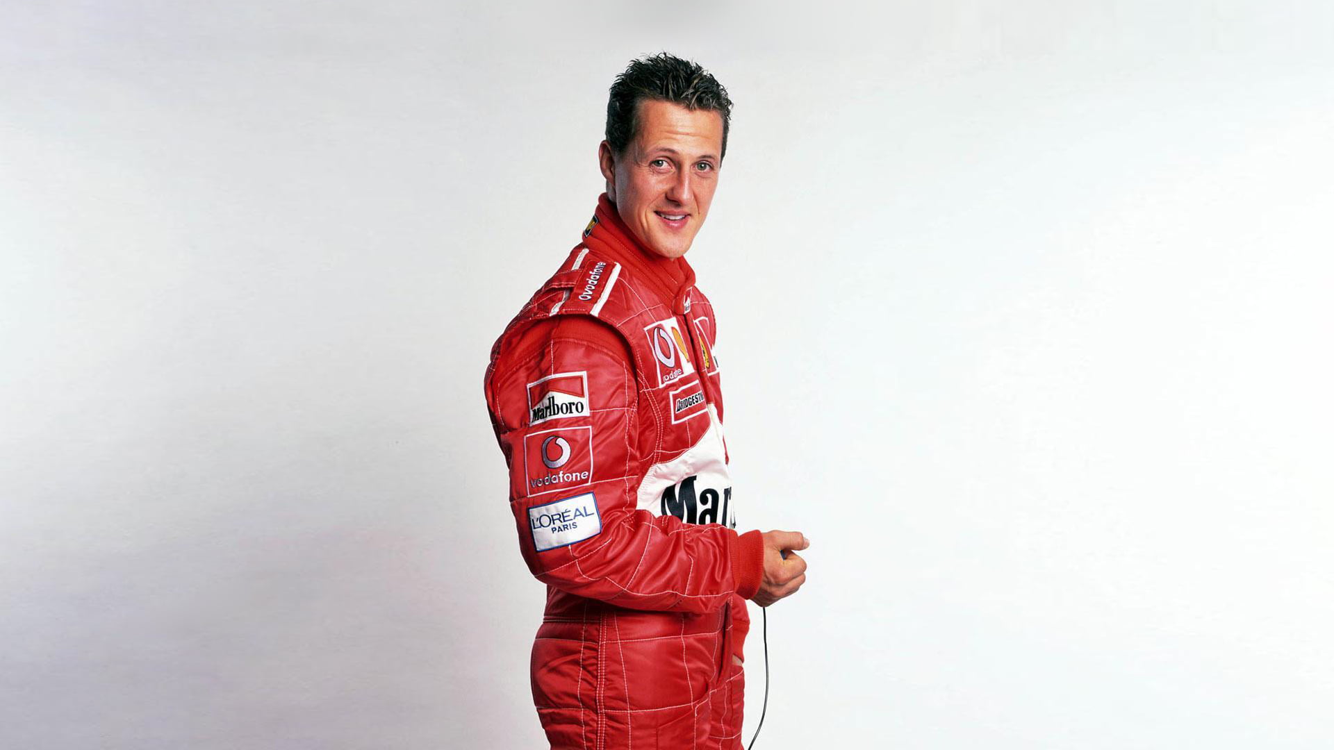 racer, young adult, looking at camera, Michael Schumacher, red, men, casual clothing, 1080P, confidence, lifestyles, happiness, emotion, portrait, looking, HD Wallpaper