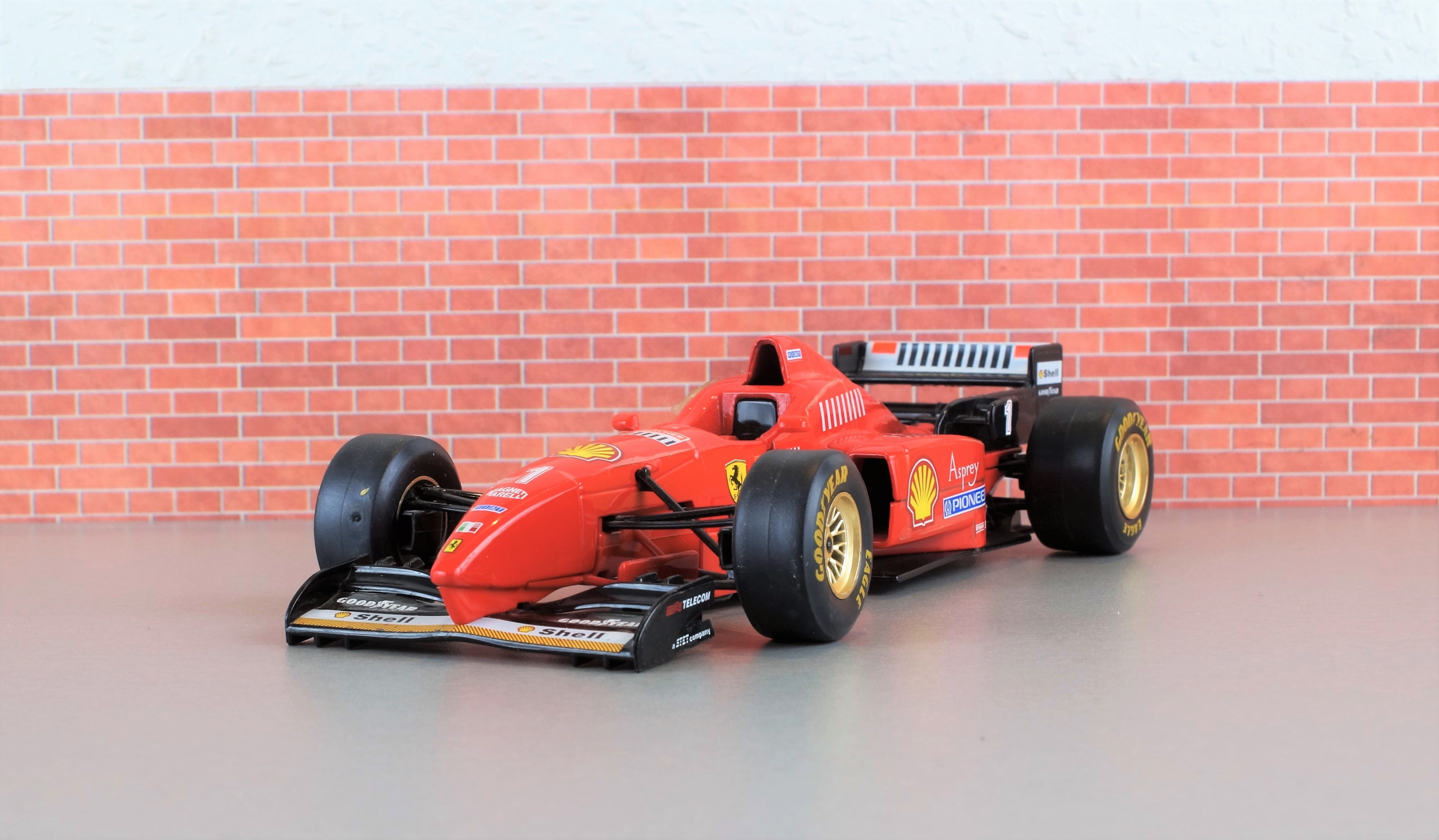 wall - building feature, wheel, fast, formula 1, auto racing, wall, toys, sports track, motor racing track, red, model car, model, f310, indoors, automotive, HD Wallpaper