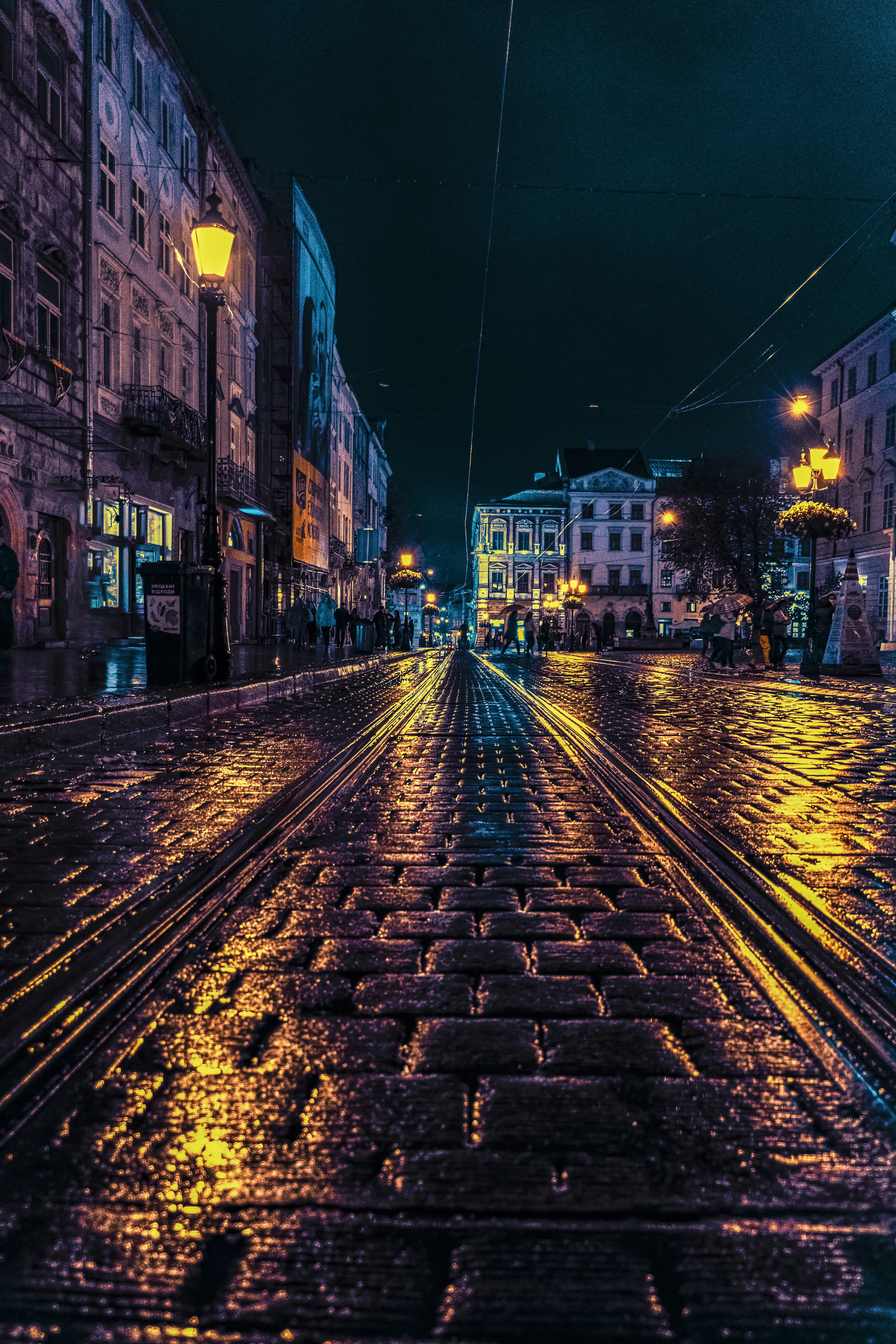 travel, long, concrete, built structure, lamp posts, architecture, illuminated, buildings, night, nature, cobblestone street, town, road, rail transportation, Phone HD Wallpaper