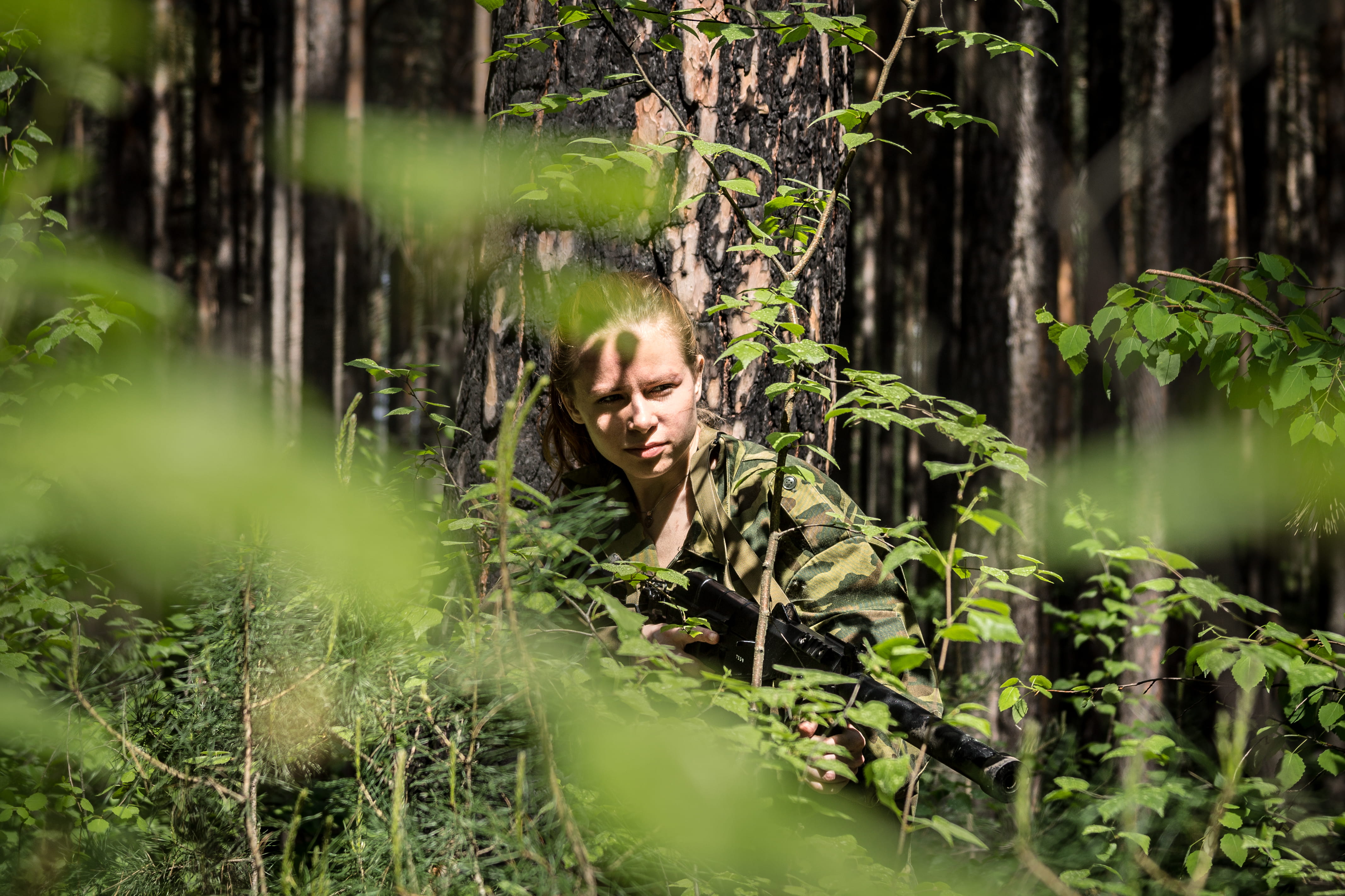 smiling, tree trunk, front view, nature, 4K, tree, leisure activity, tactical, russia, real people, submachine, airsoft, outdoors, novosibirsk, green color, HD Wallpaper