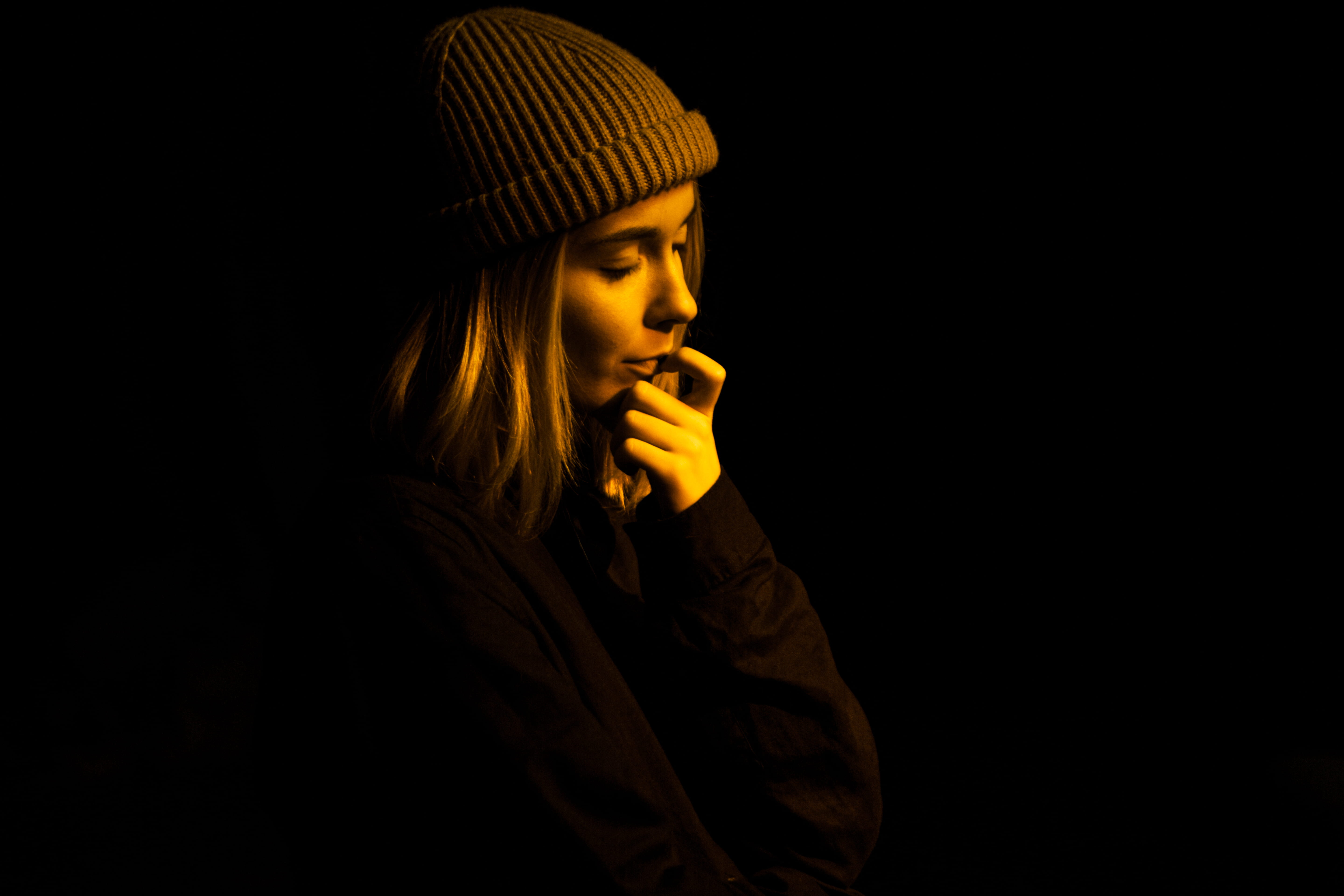 fashion, dark, hairstyle, studio shot, hand on face, beauty, yellow light, putting, headshot, woman, calm, dream, gold, contemplation, beautiful people, HD Wallpaper