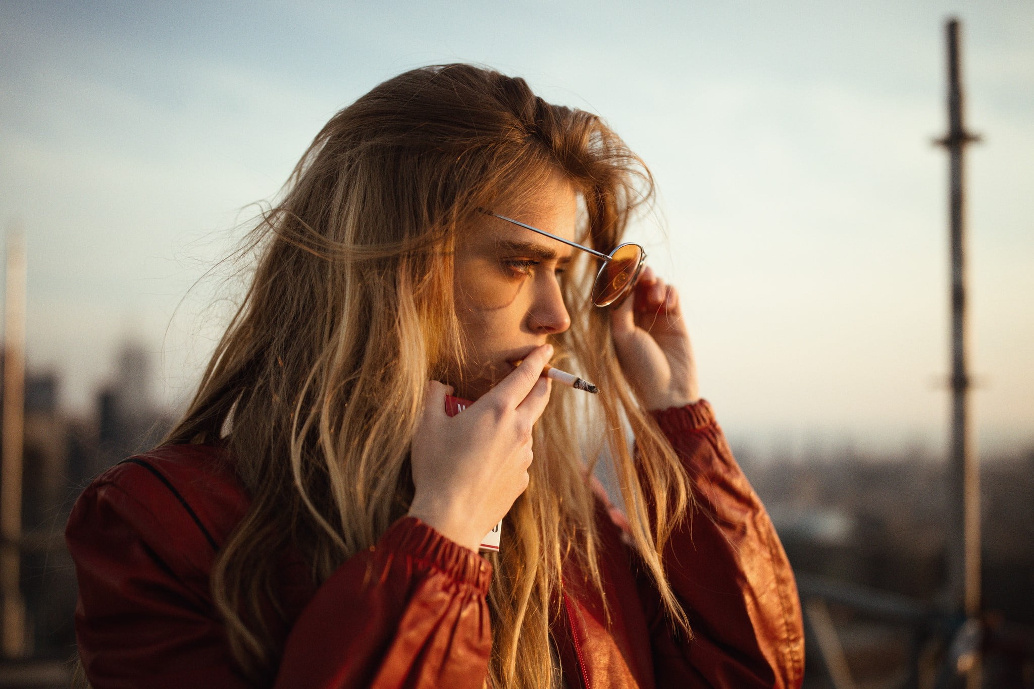 beautiful woman, contemplation, city, Marta Piekarz, nature, smoking, adult, model, 1080P, long hair, scarf, orange jacket, women, lifestyles, sunset, HD Wallpaper