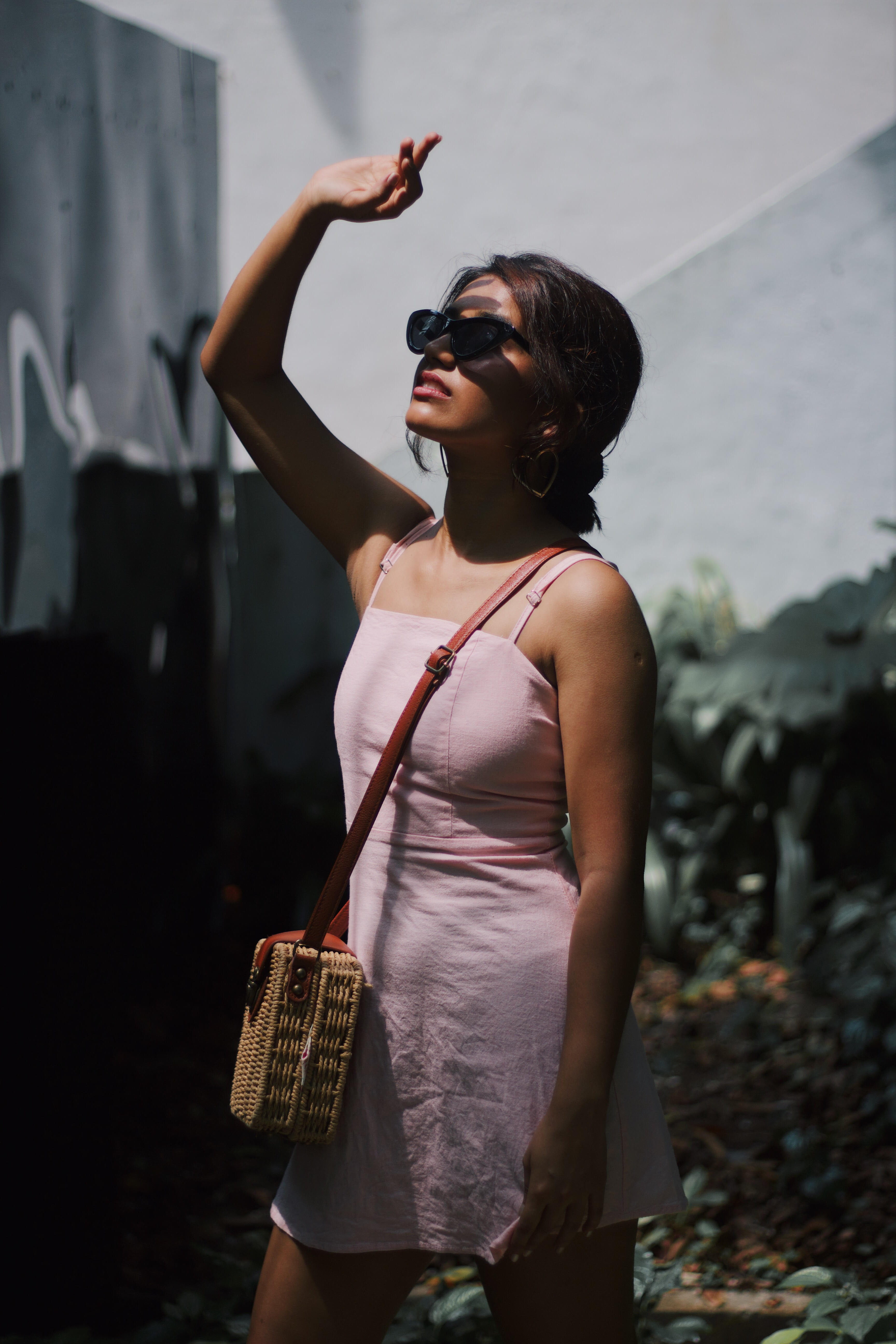 arms raised, portrait, shade, three quarter length, shadow, glasses, front view, real people, one person, photography, standing, sunglasses, young women, Phone HD Wallpaper