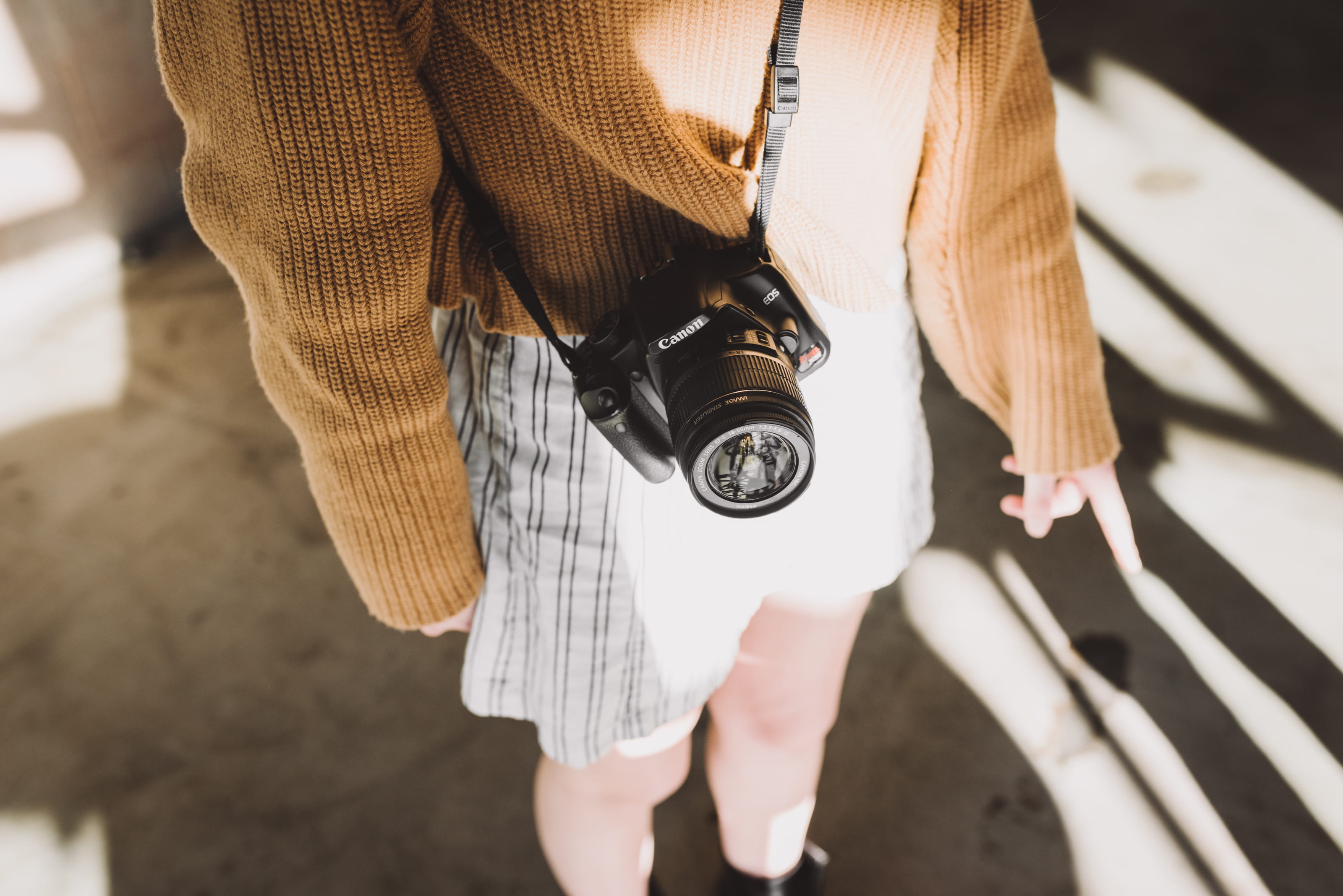 women, ground, adult, camera, woman, focus on foreground, camera - photographic equipment, 2K, human body part, shorts, holding, midsection, concrete, HD Wallpaper