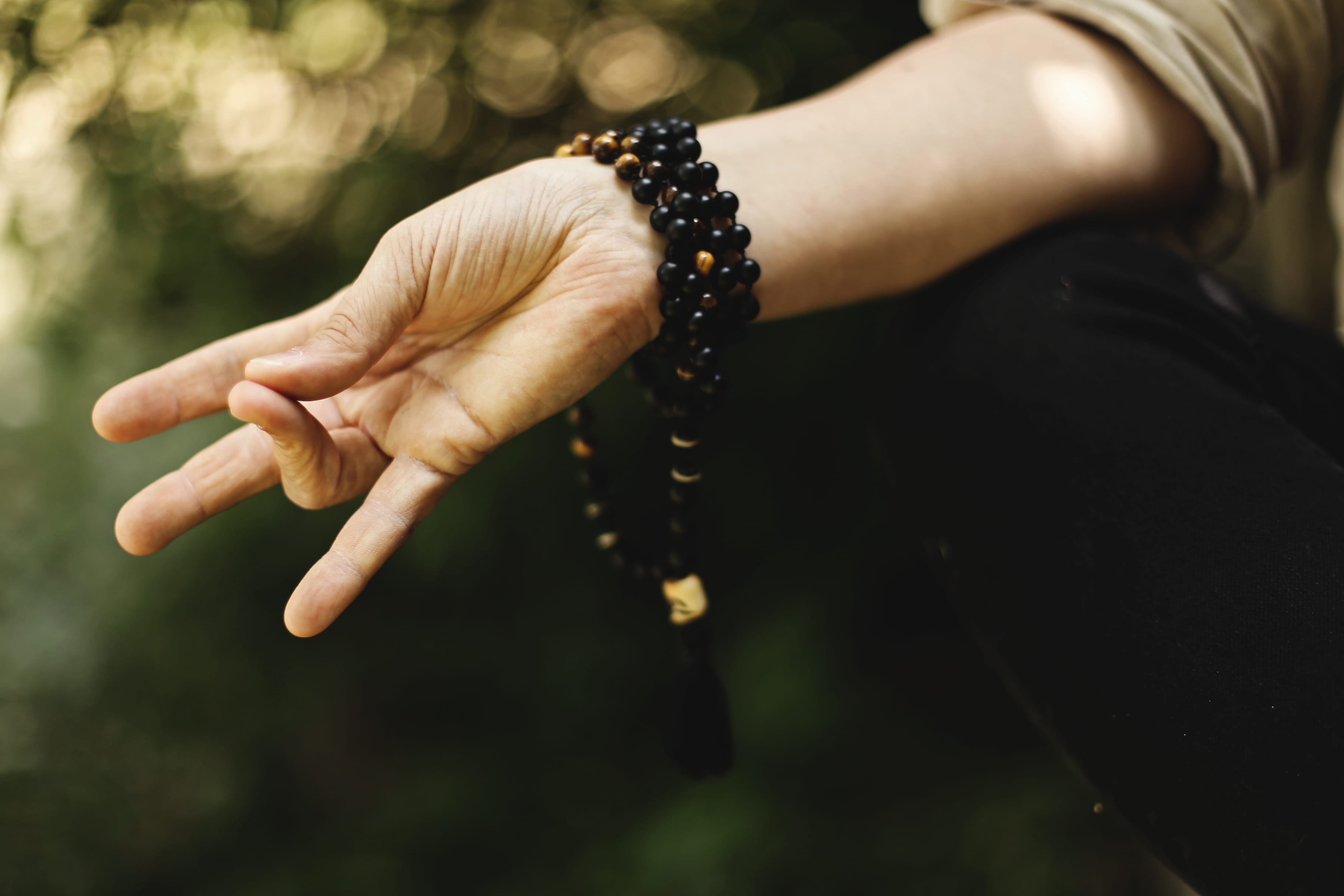 focus on foreground, human limb, bead, emotion, body part, mala, human body part, dark, close-up, bracelets, bracelet, people, finger, day, gesture, hand, HD Wallpaper